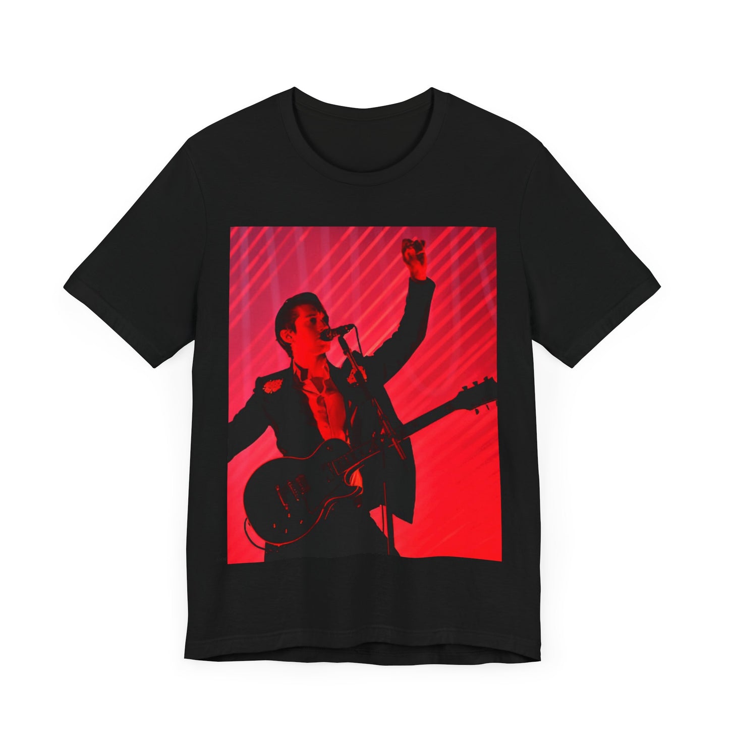 A black graphic t-shirt featuring a dynamic graphic or photo of Arctic Monkeys performing live in concert.