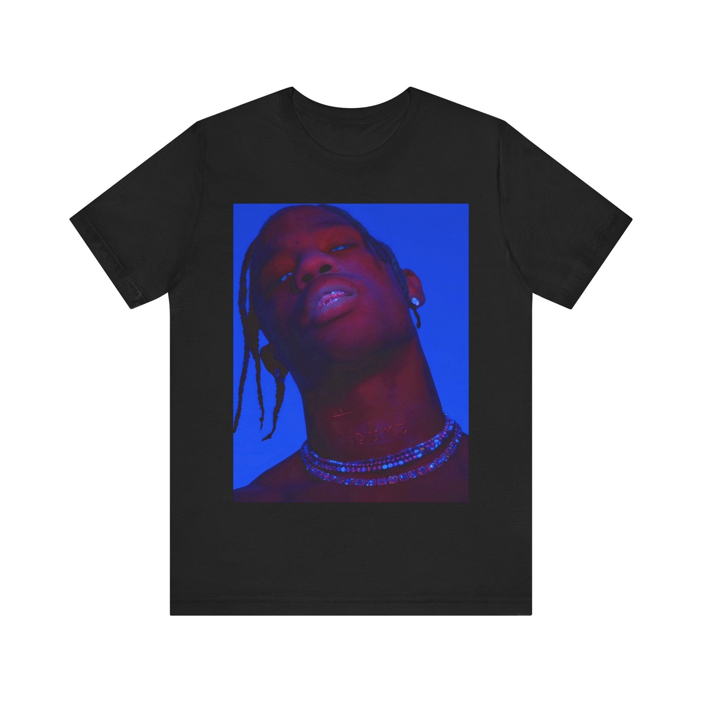 A black graphic t-shirt featuring a bold graphic of Travis Scott as a rap superstar.
