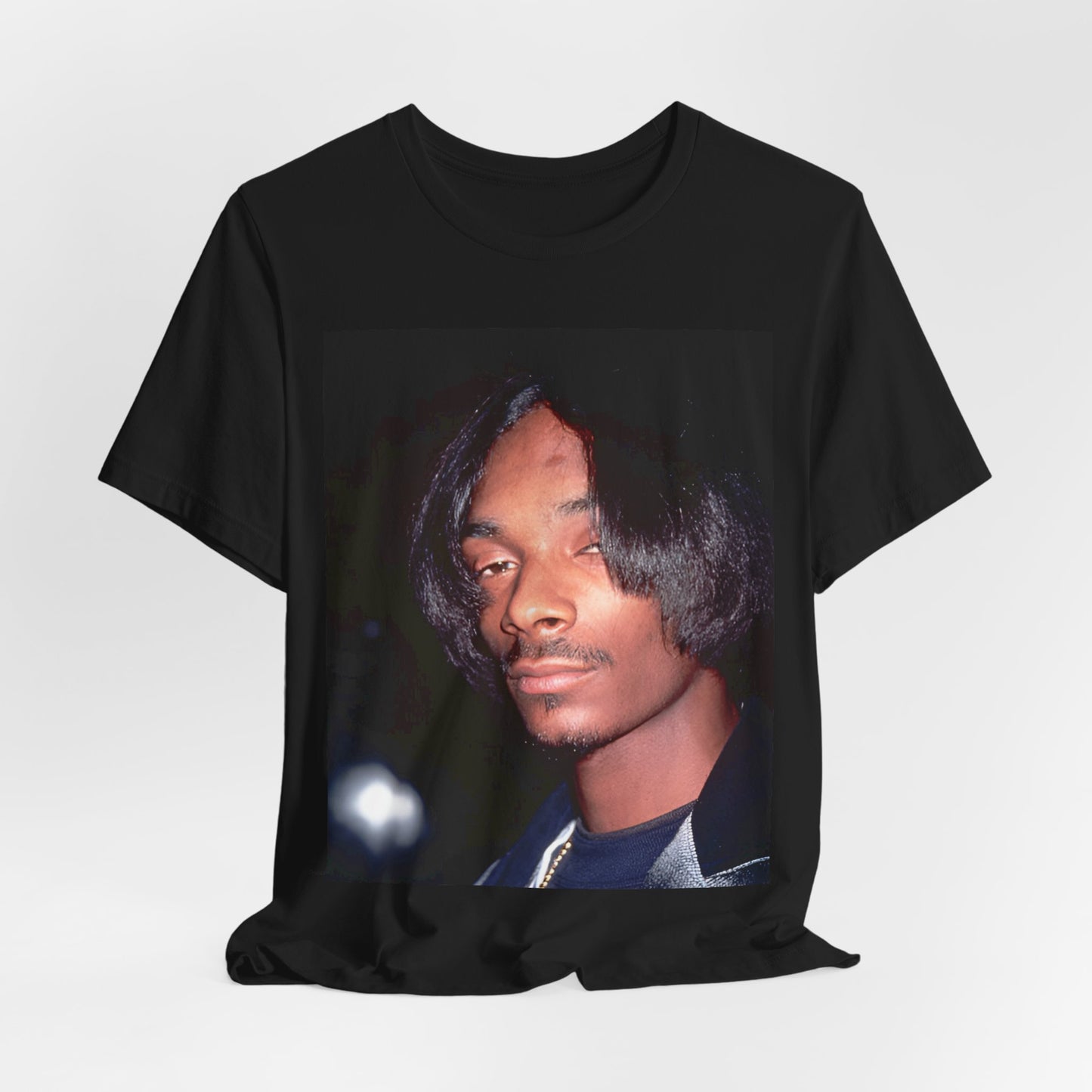 A black graphic t-shirt featuring a 90s black and white graphic of Snoop Dogg as a global icon in rap.