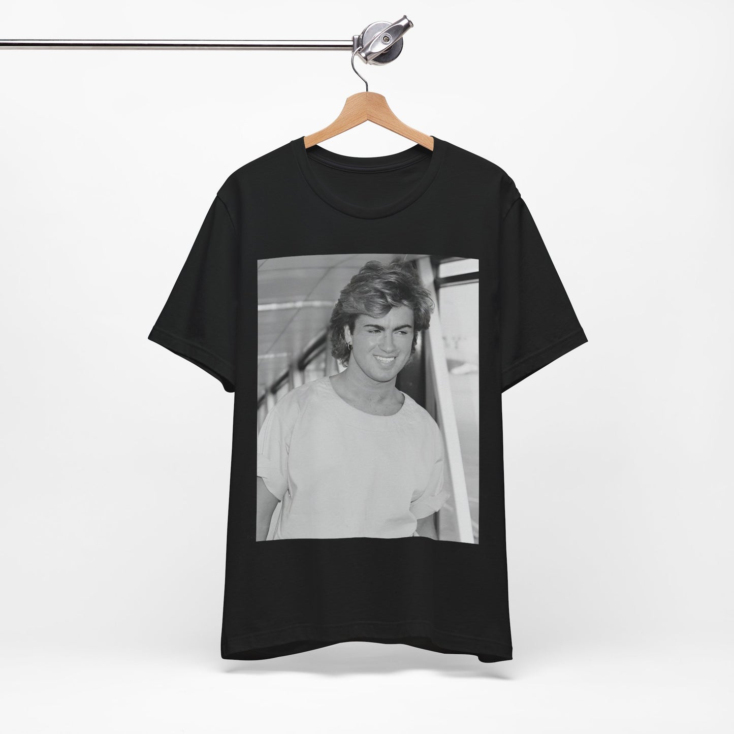 A black graphic t-shirt featuring an 80s black and white vintage photo or graphic of George Michael.