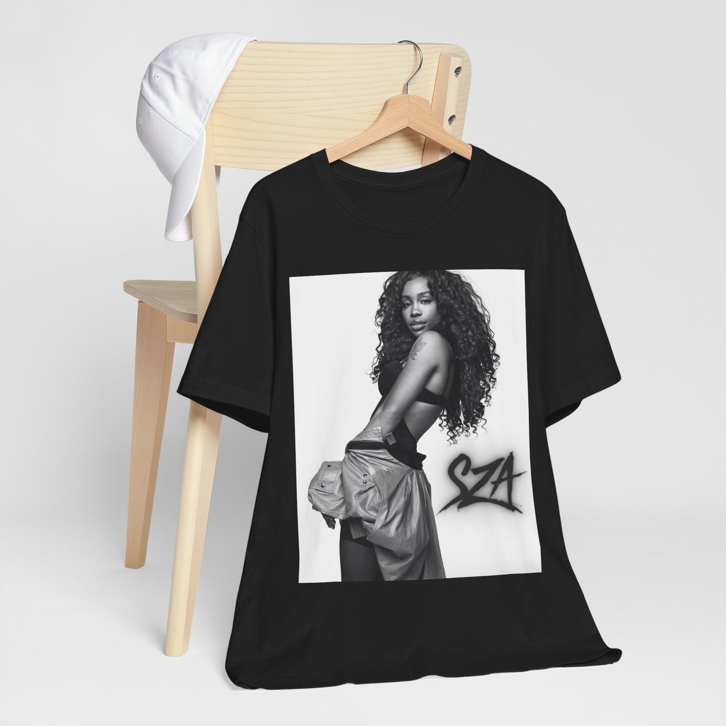 A black graphic t-shirt featuring a black and white portrait photo of SZA.