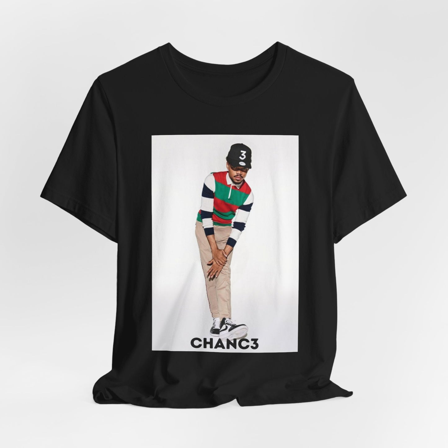 A black graphic t-shirt featuring a graphic of Chance the Rapper with a positive or 'feel good' hip hop vibe.
