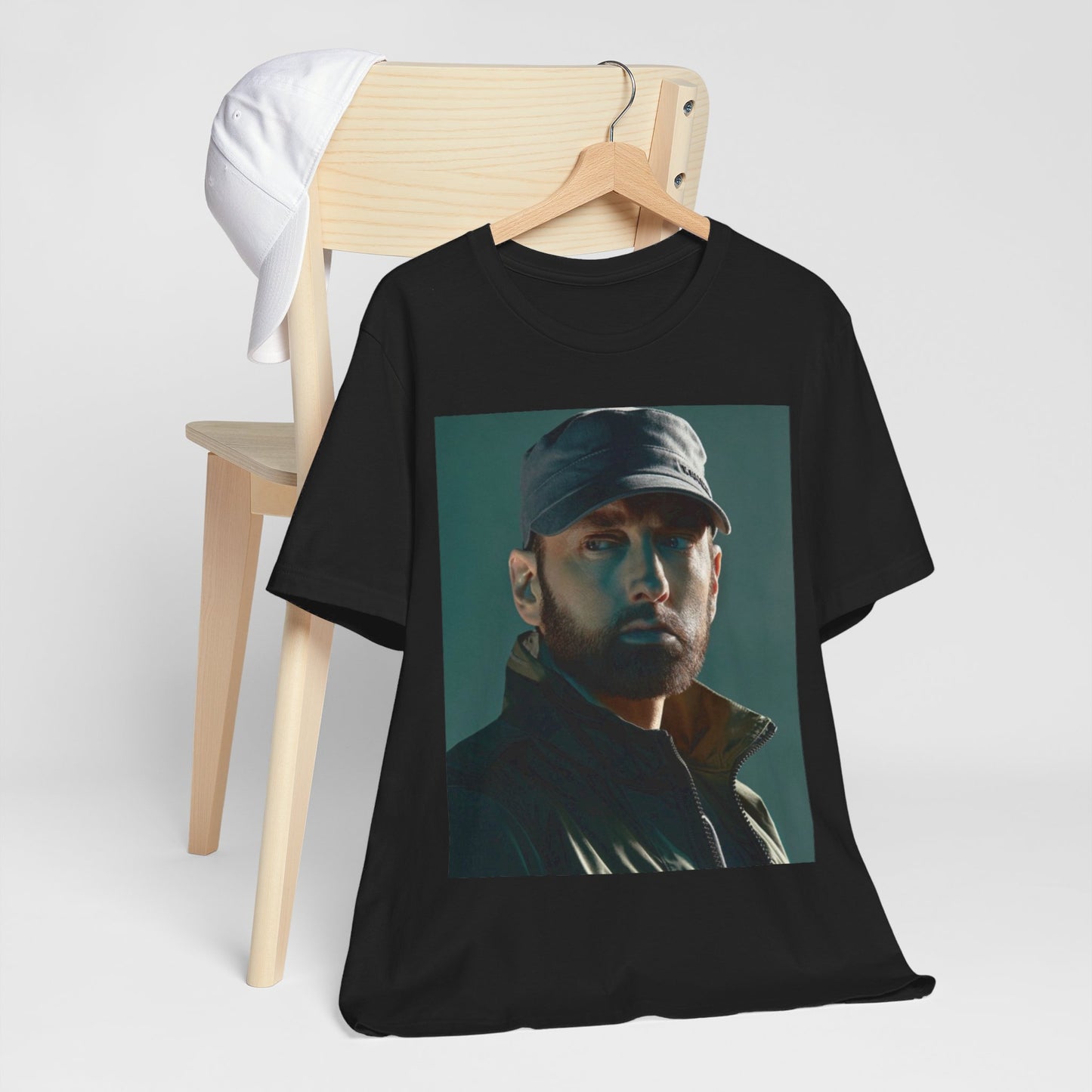A black graphic t-shirt featuring a graphic of Eminem as a rap genius.