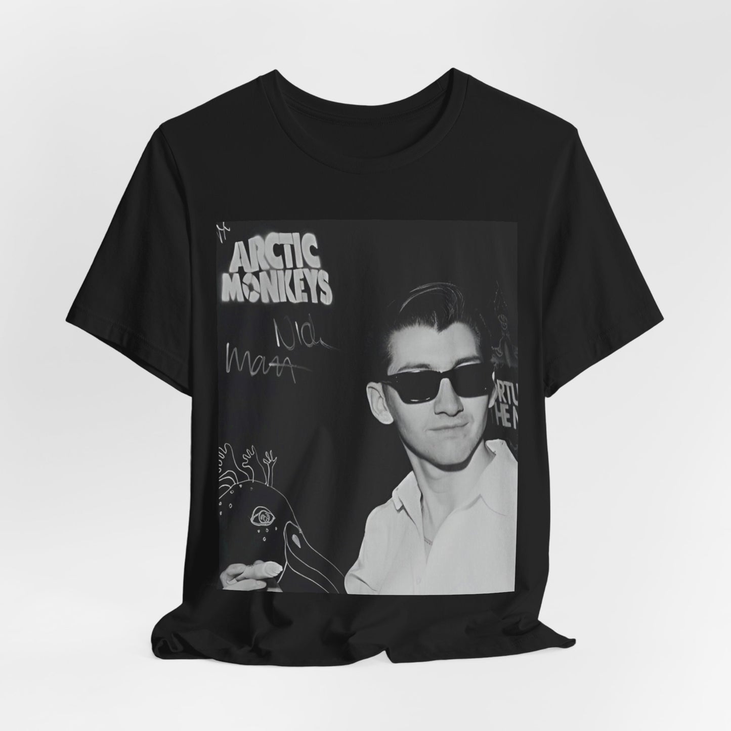A black graphic t-shirt featuring a black and white portrait photo of Alex Turner from Arctic Monkeys, showing his signature look.