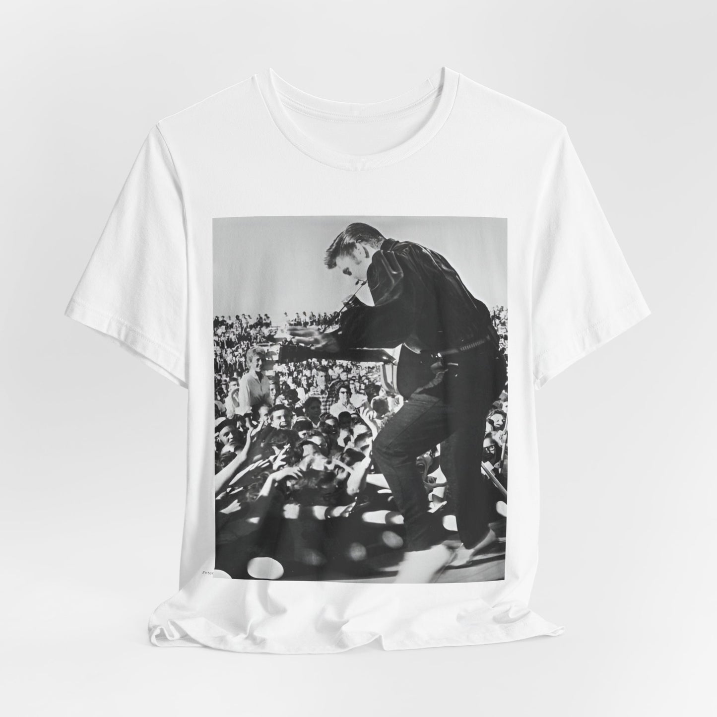 A black graphic t-shirt featuring a retro photo of Elvis Presley performing live in concert in the 1950s.