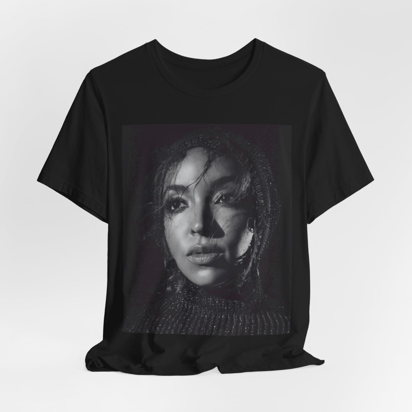 A black graphic t-shirt featuring a black and white portrait photo of Tinashe.