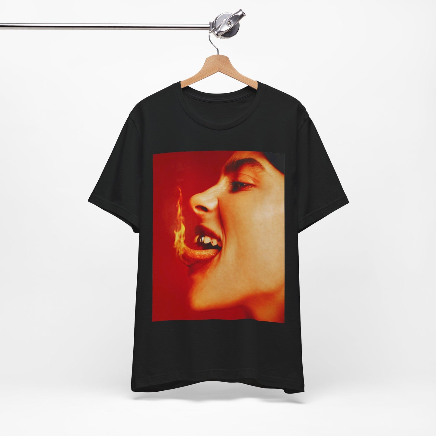 A close-up, red-toned photo of a face in profile with its mouth open and a live flame on the tongue, printed on a graphic t-shirt.