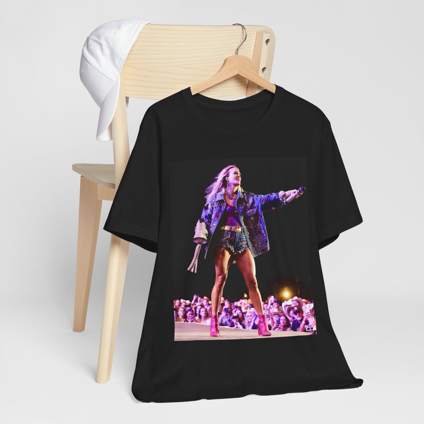 A black graphic t-shirt featuring a graphic of Carrie Underwood with Nashville-themed elements or skyline.