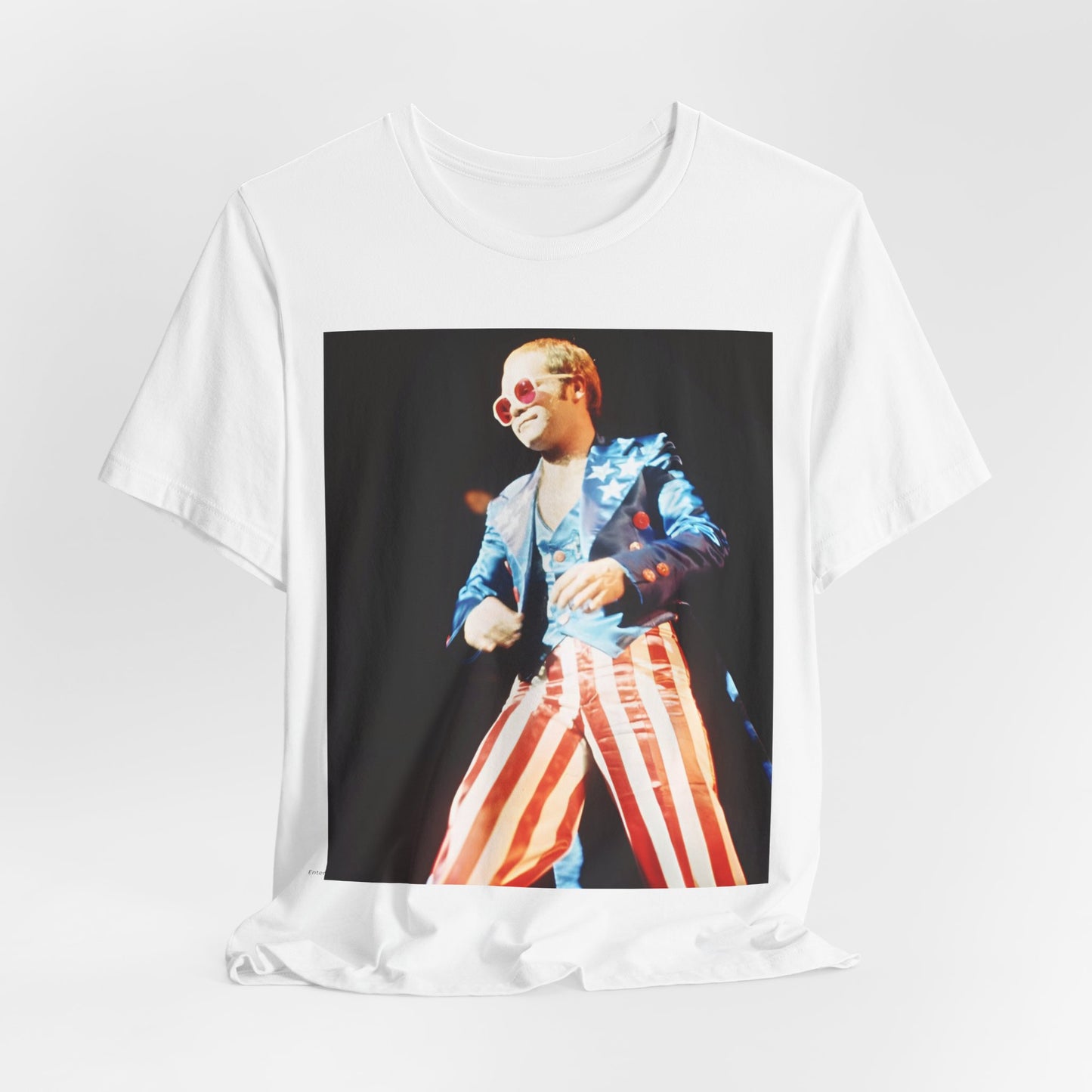 A black graphic t-shirt featuring a graphic related to Elton John's 70s America tour.