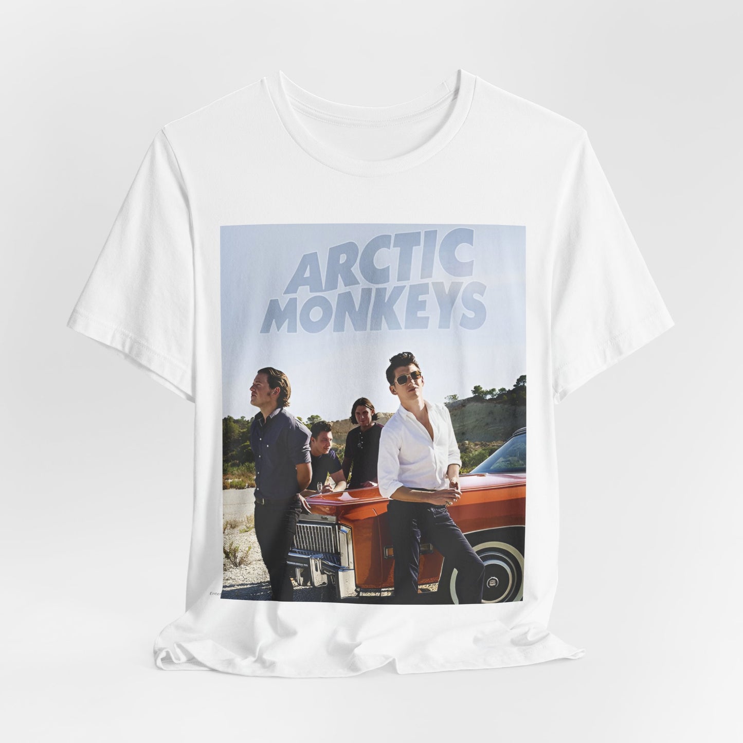 A black graphic t-shirt featuring a design related to Arctic Monkeys' 'AM' album era, possibly with the album art or band imagery.