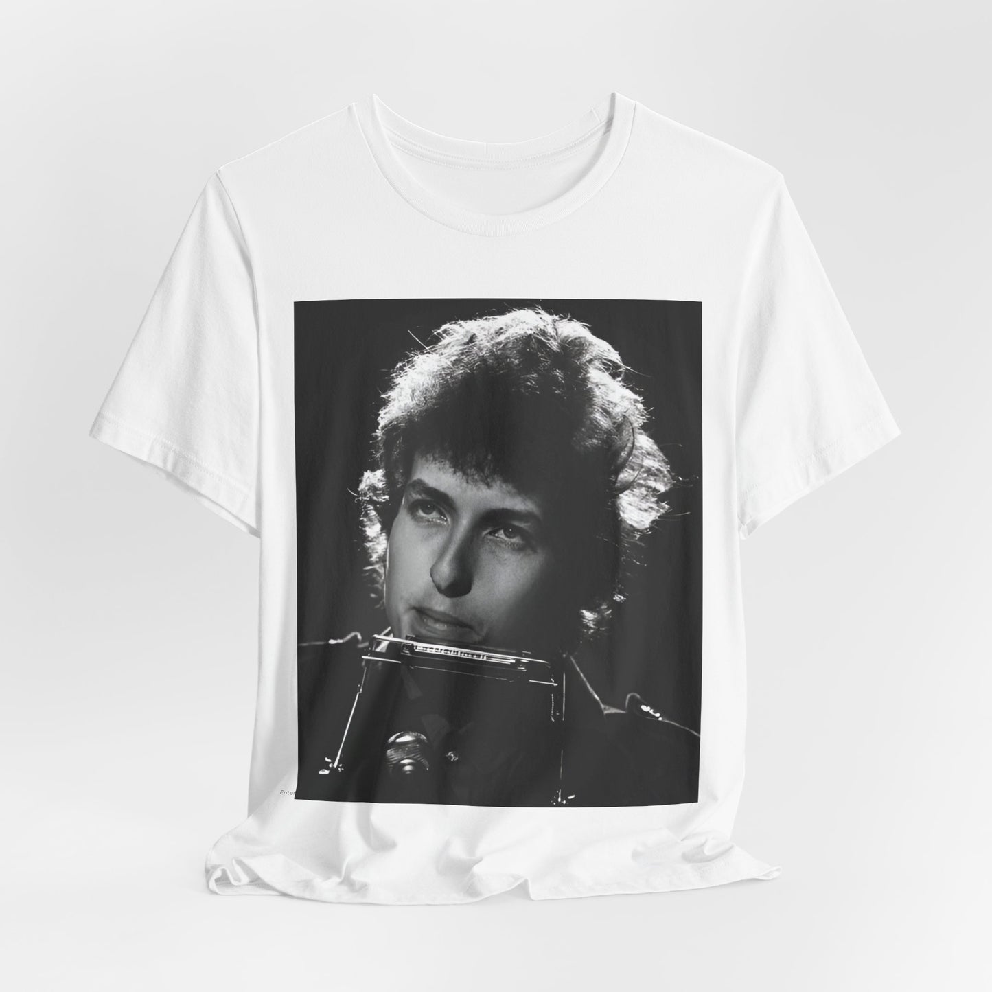 A black graphic t-shirt featuring a graphic of Bob Dylan from the 60s playing his harmonica.