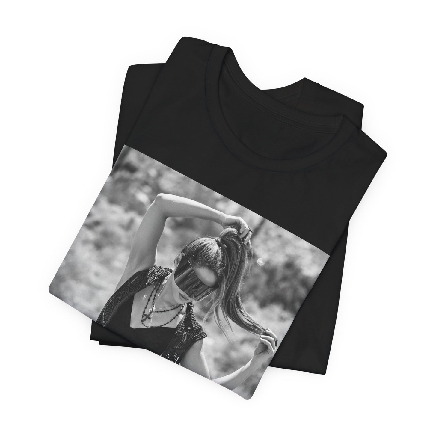 A black graphic t-shirt featuring a black and white, monochrome graphic or photo of Shakira.