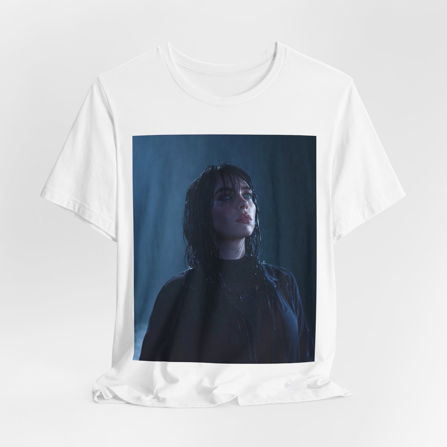 A direct, powerful portrait of Billie Eilish, embodying the 'HIT ME HARD AND SOFT' album era, printed on a graphic t-shirt.