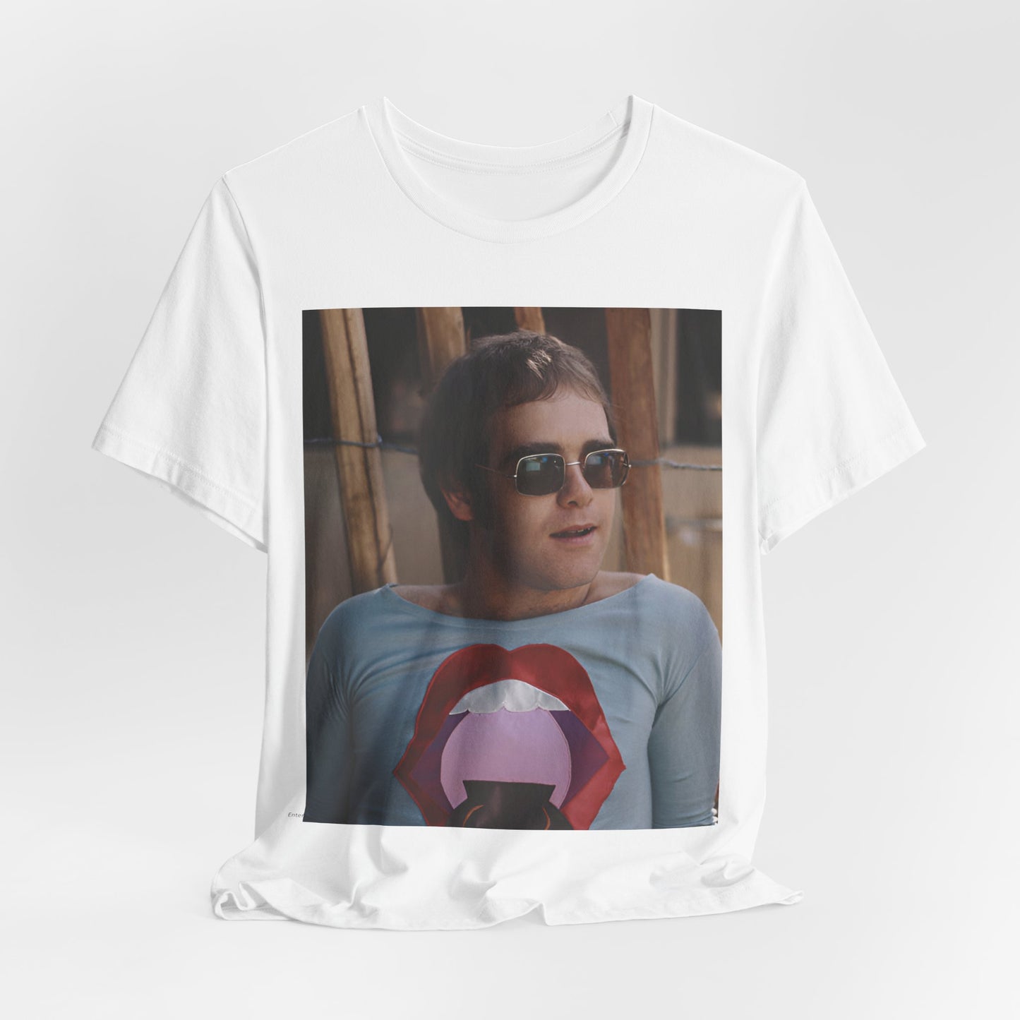 A black graphic t-shirt featuring a classic graphic related to Elton John's 'Tiny Dancer' song or era.