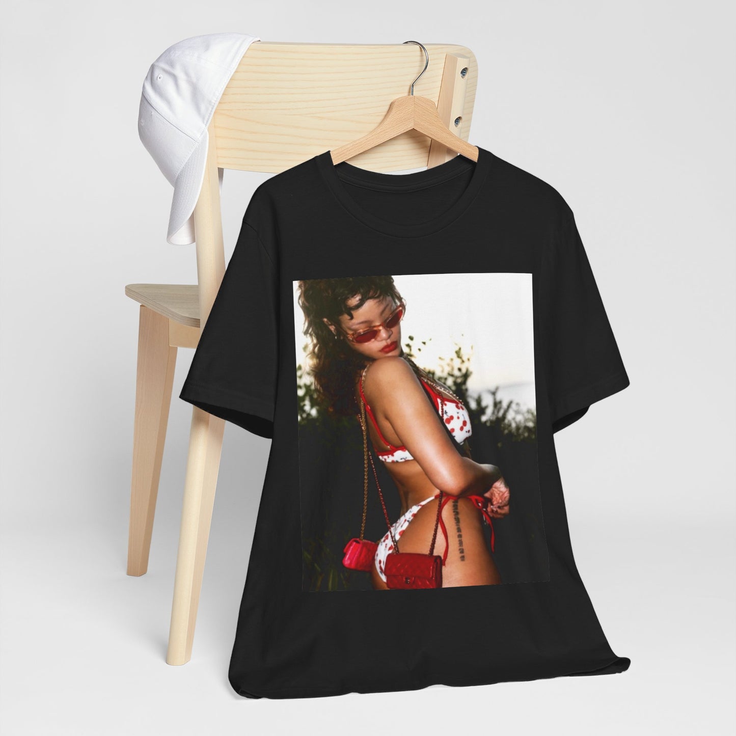 A black graphic t-shirt featuring a photo graphic of Rihanna in a bikini.