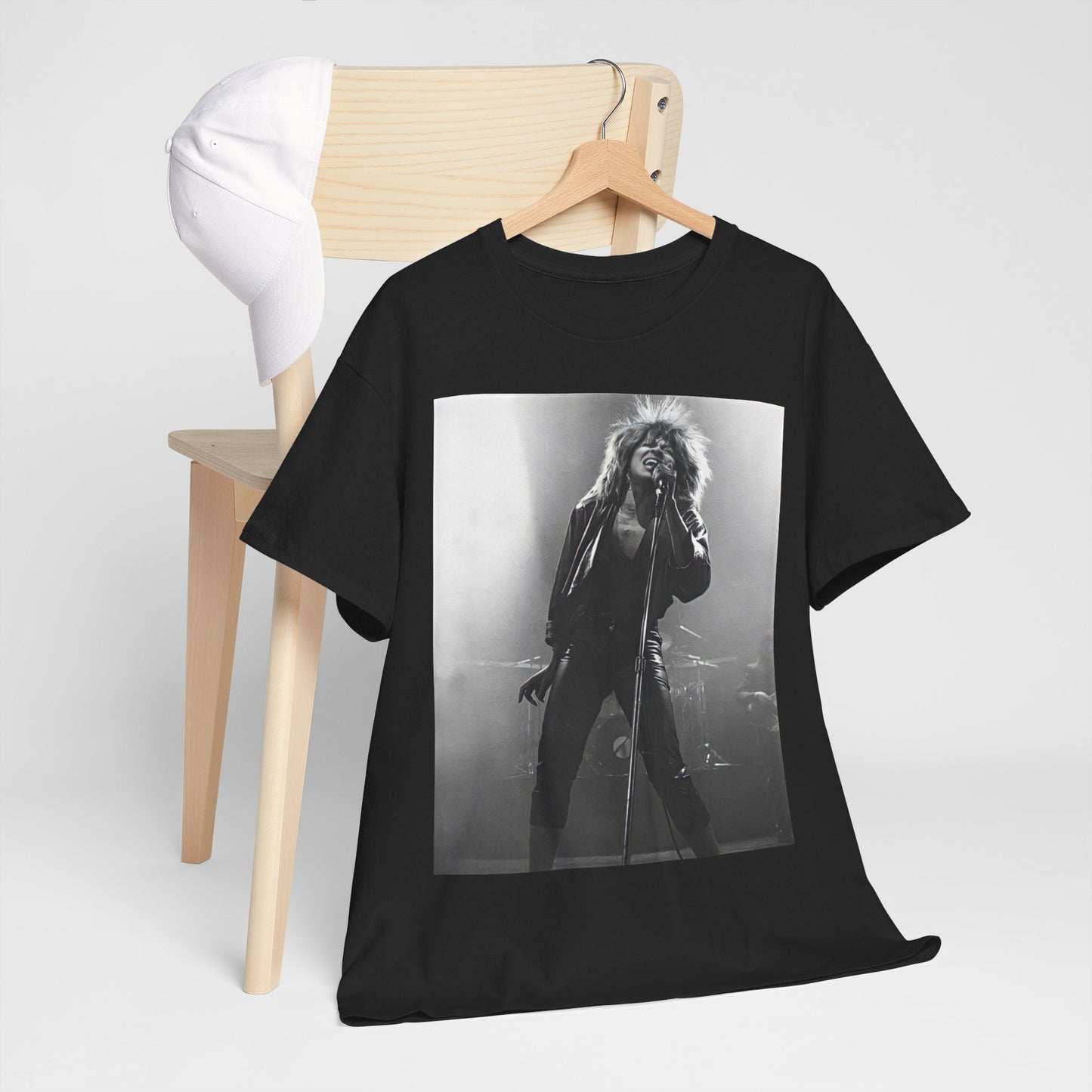 A black graphic t-shirt featuring a graphic of Tina Turner performing "Proud Mary" live.