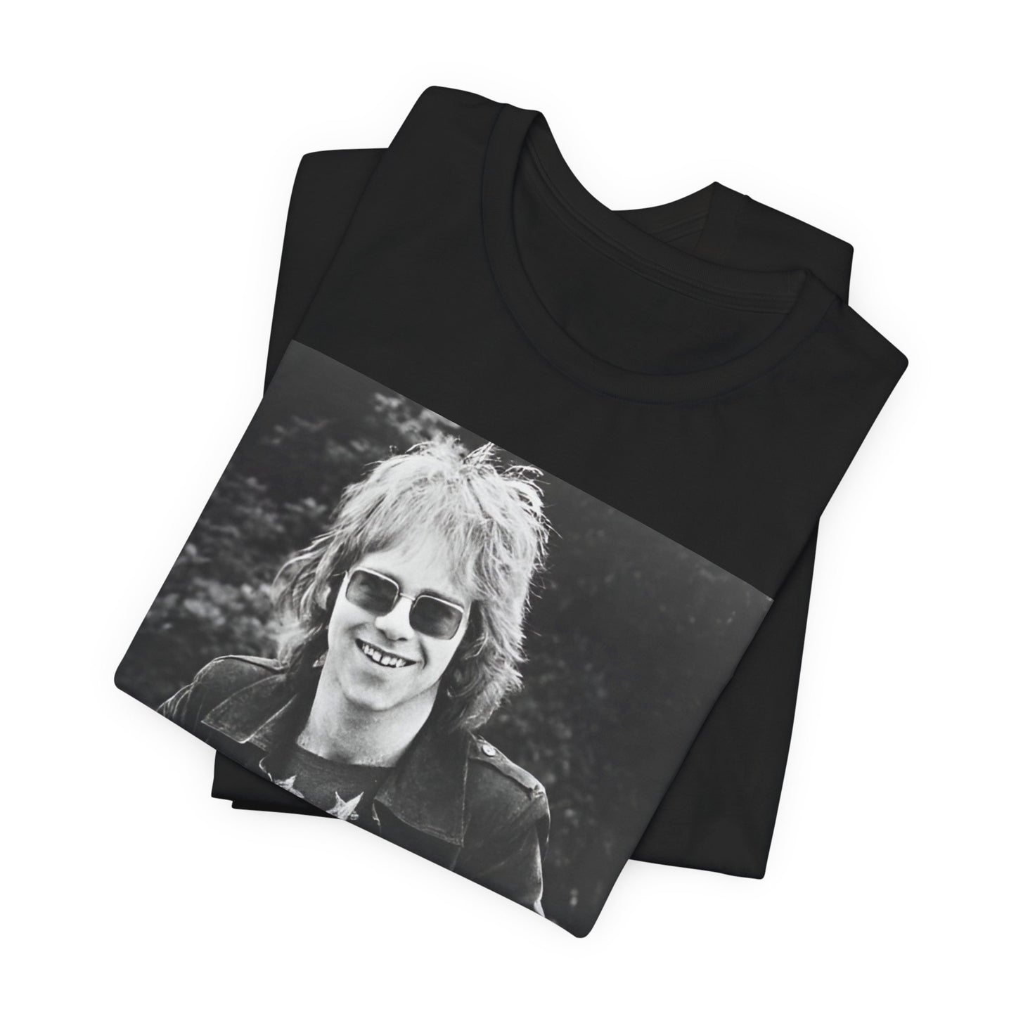 A black graphic t-shirt featuring a 70s black and white monochrome graphic or photo of Elton John.
