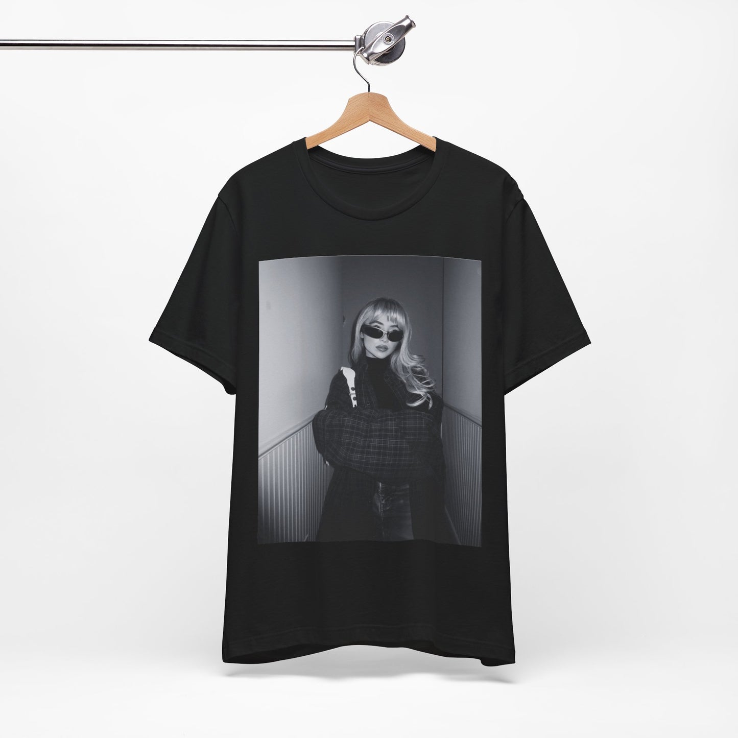 A black graphic t-shirt featuring a black and white glam pop diva graphic of Sabrina Carpenter.