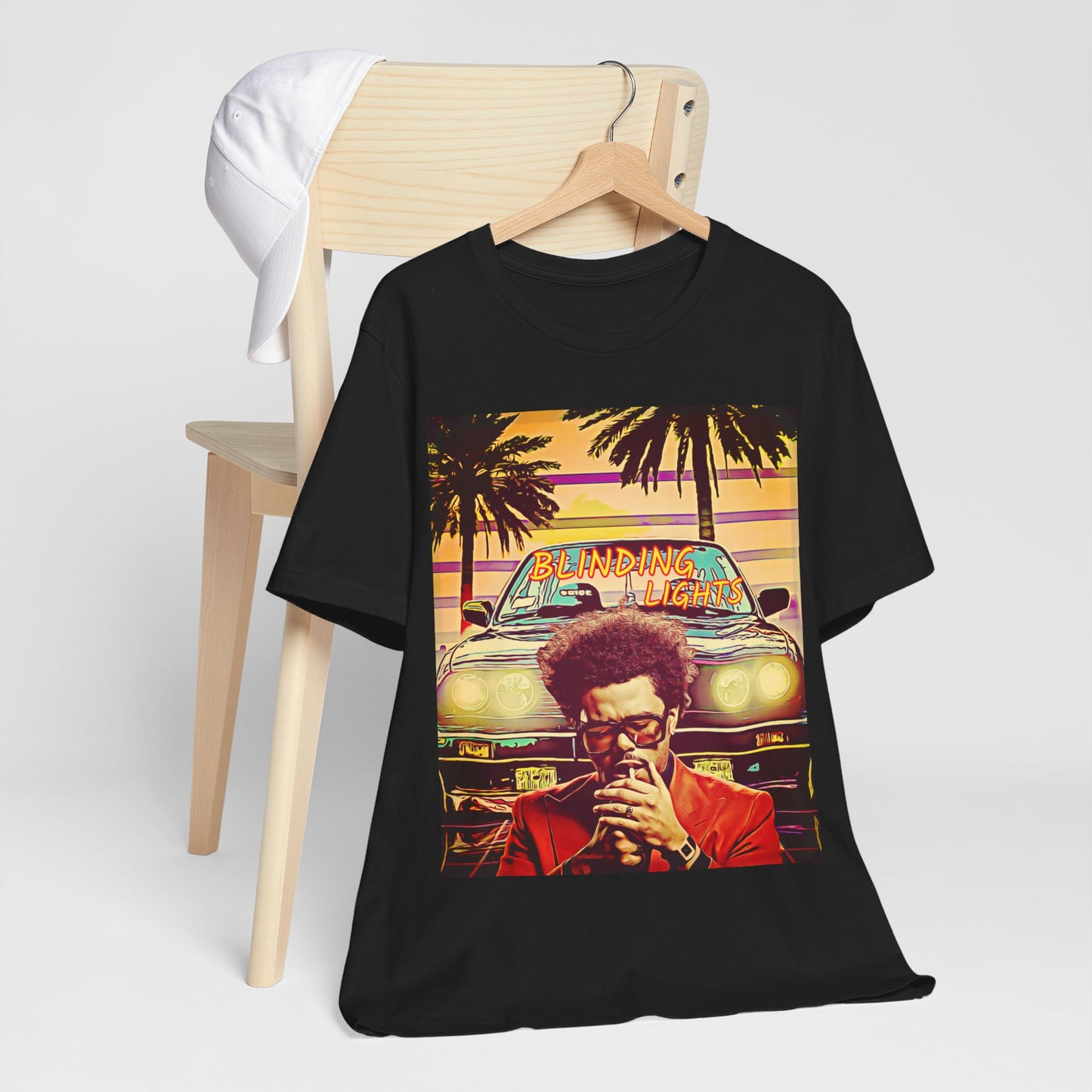 A black graphic t-shirt featuring a graphic related to The Weeknd's 'Blinding Lights' song.