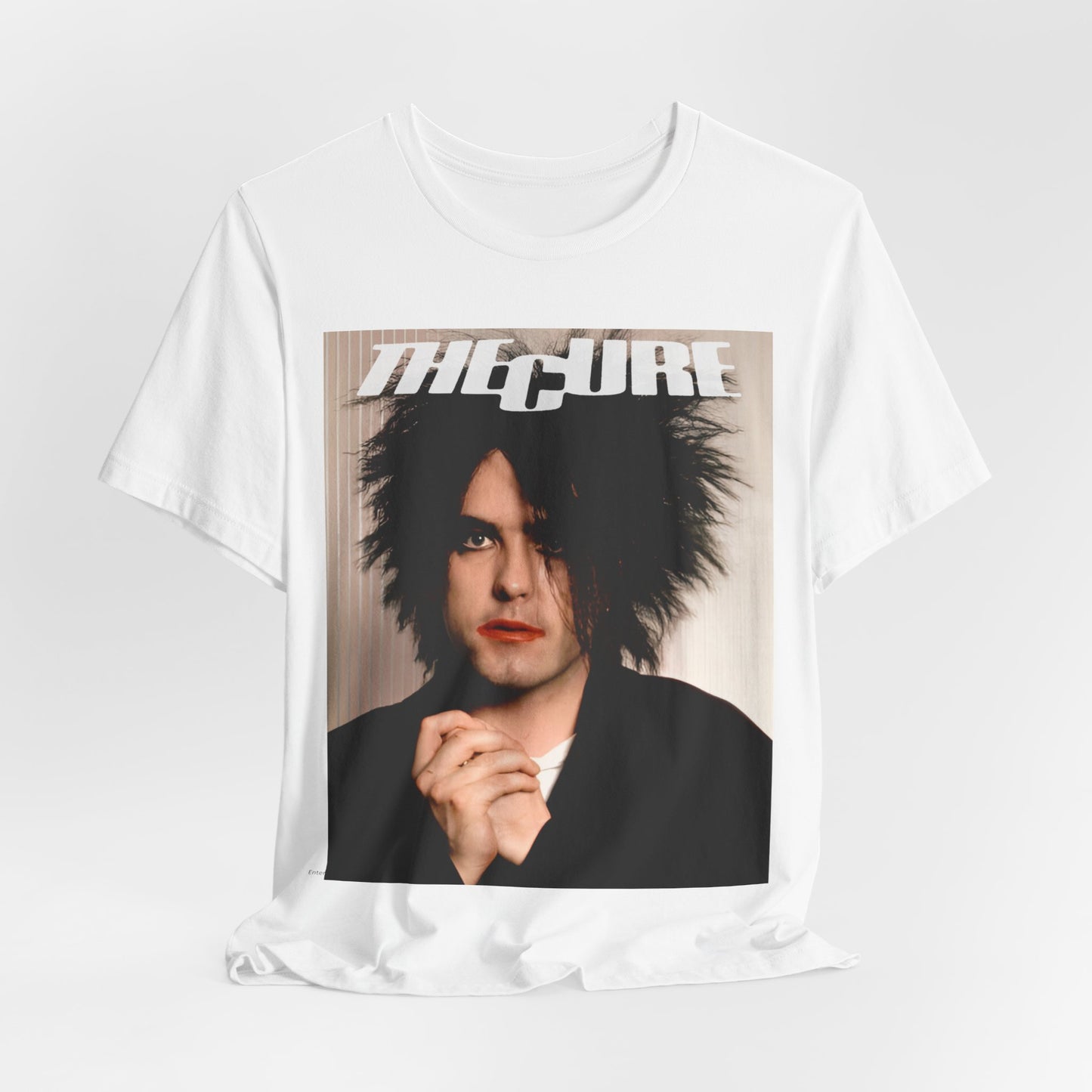 A black graphic t-shirt featuring a 90s portrait photo of Robert Smith from The Cure.