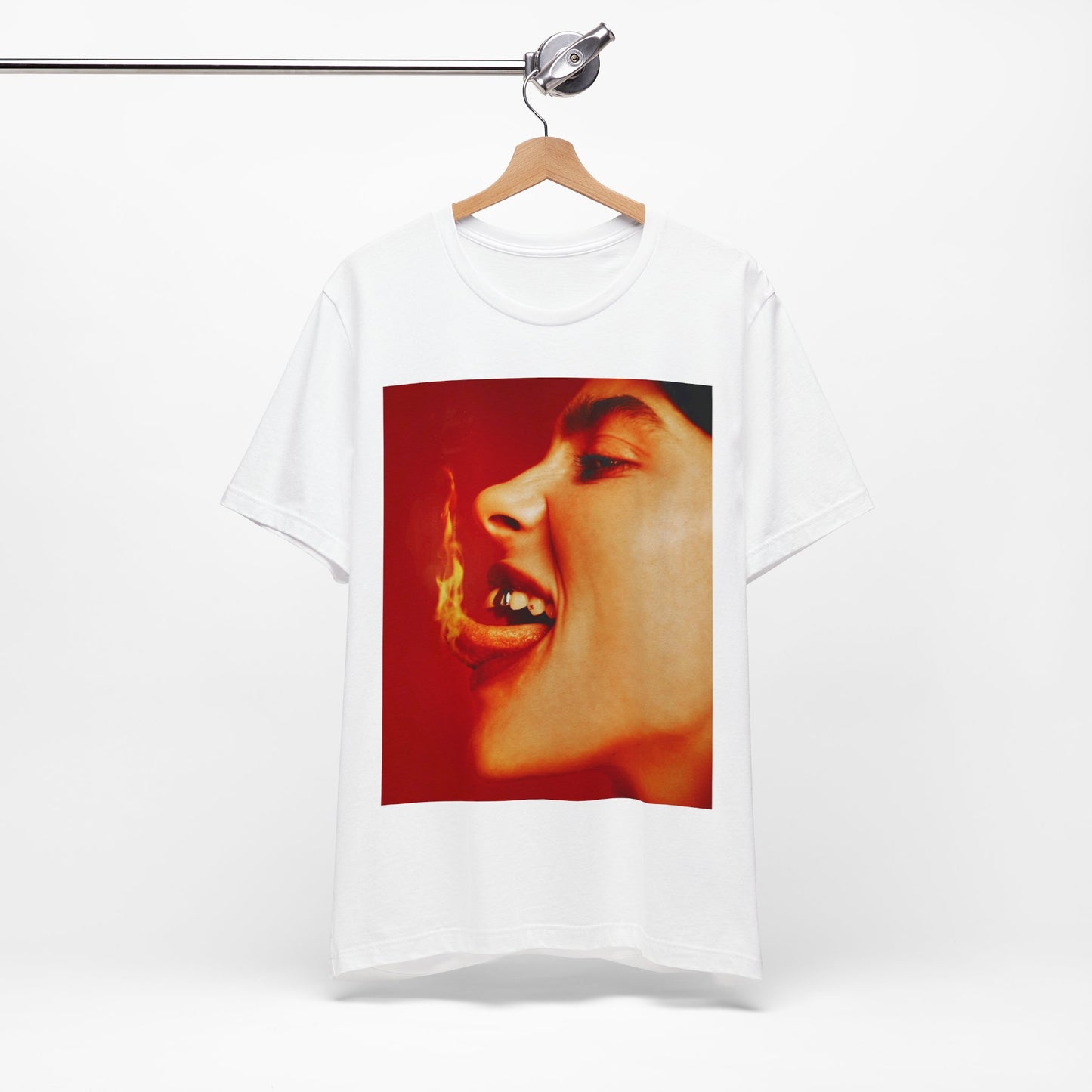 A close-up, red-toned photo of a face in profile with its mouth open and a live flame on the tongue, printed on a graphic t-shirt.