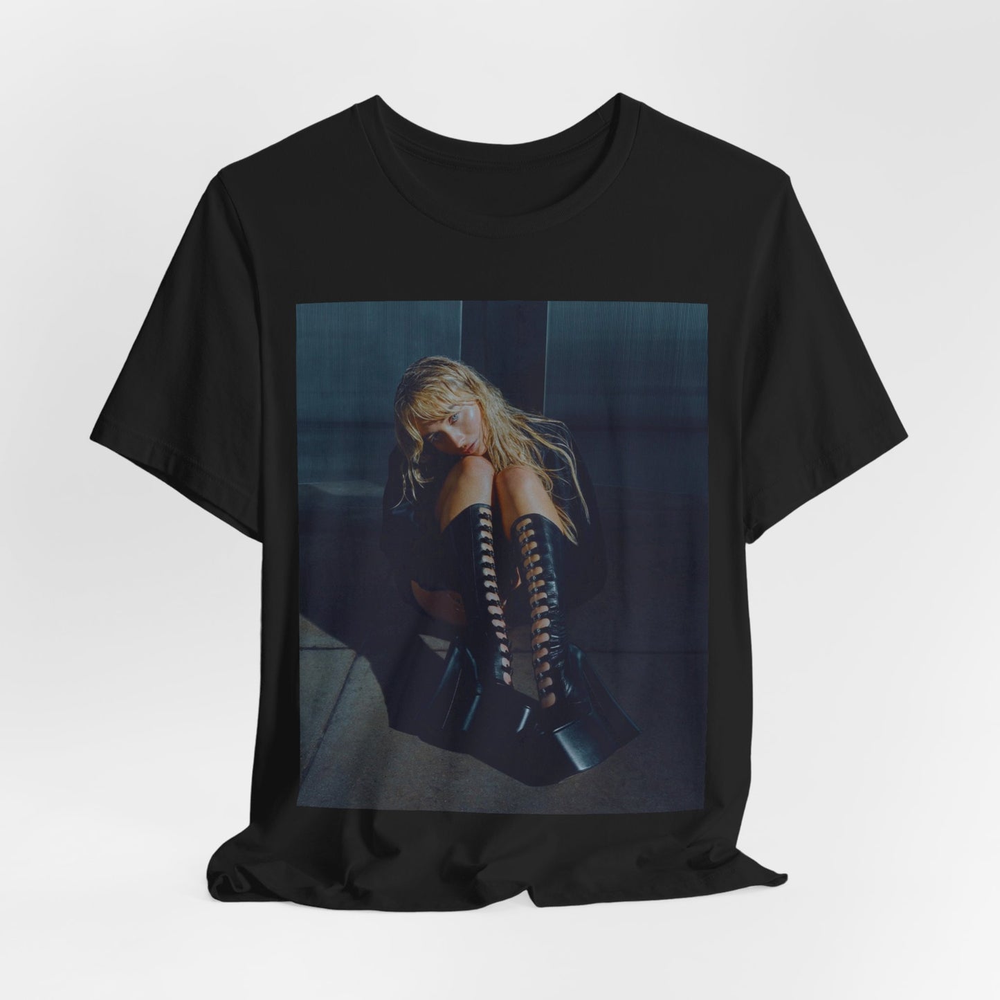 A black graphic t-shirt featuring a bold graphic of Sabrina Carpenter as a pop superstar.