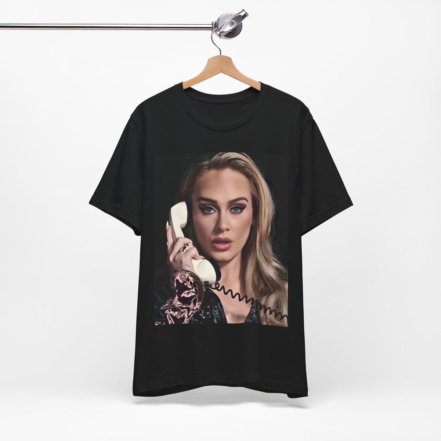 A black graphic t-shirt featuring a black and white candid photo of Adele with a phone to her ear, showing a thoughtful or emotional expression.