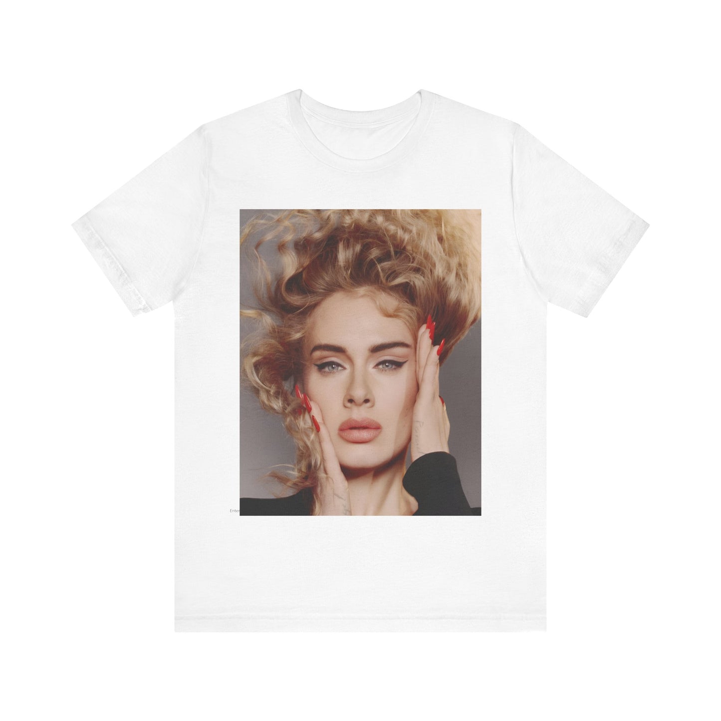 A black graphic t-shirt featuring a detailed, artistic black and white portrait of Adele with her hair dramatically caught in a breeze around her face and her hands gently placed on her cheeks.