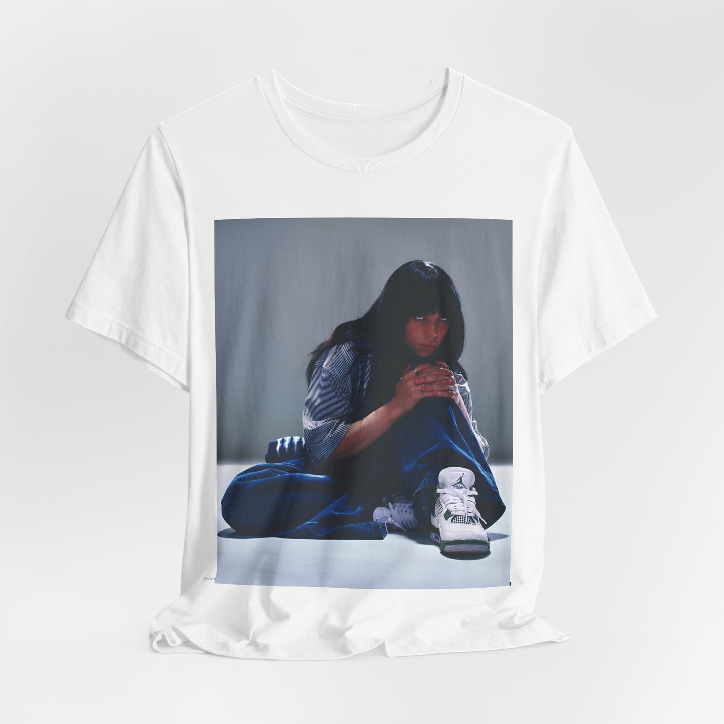 An artistic and slightly melancholic graphic t-shirt inspired by Billie Eilish's song "Lovely," featuring soft colors and a dreamy style.