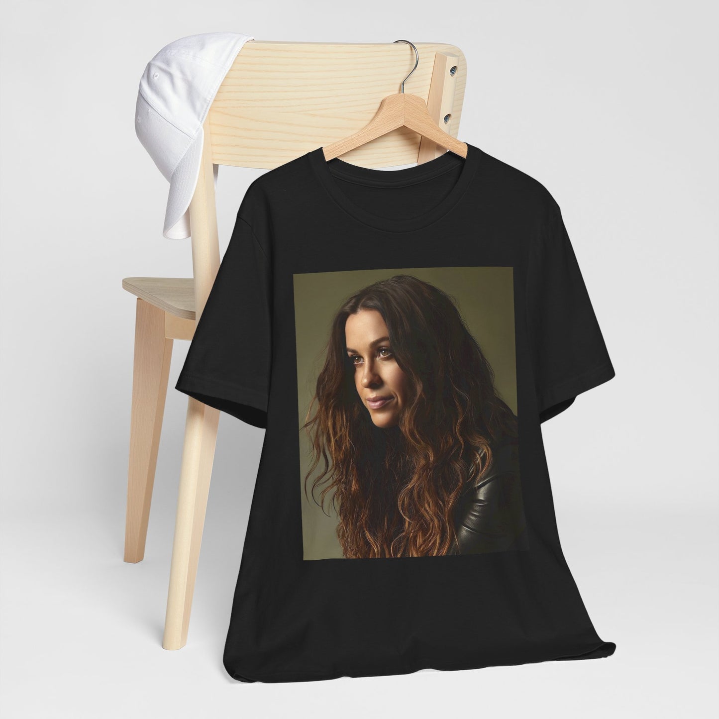 A black graphic t-shirt featuring a close-up portrait photo of Alanis Morissette, showing her intense or contemplative expression.