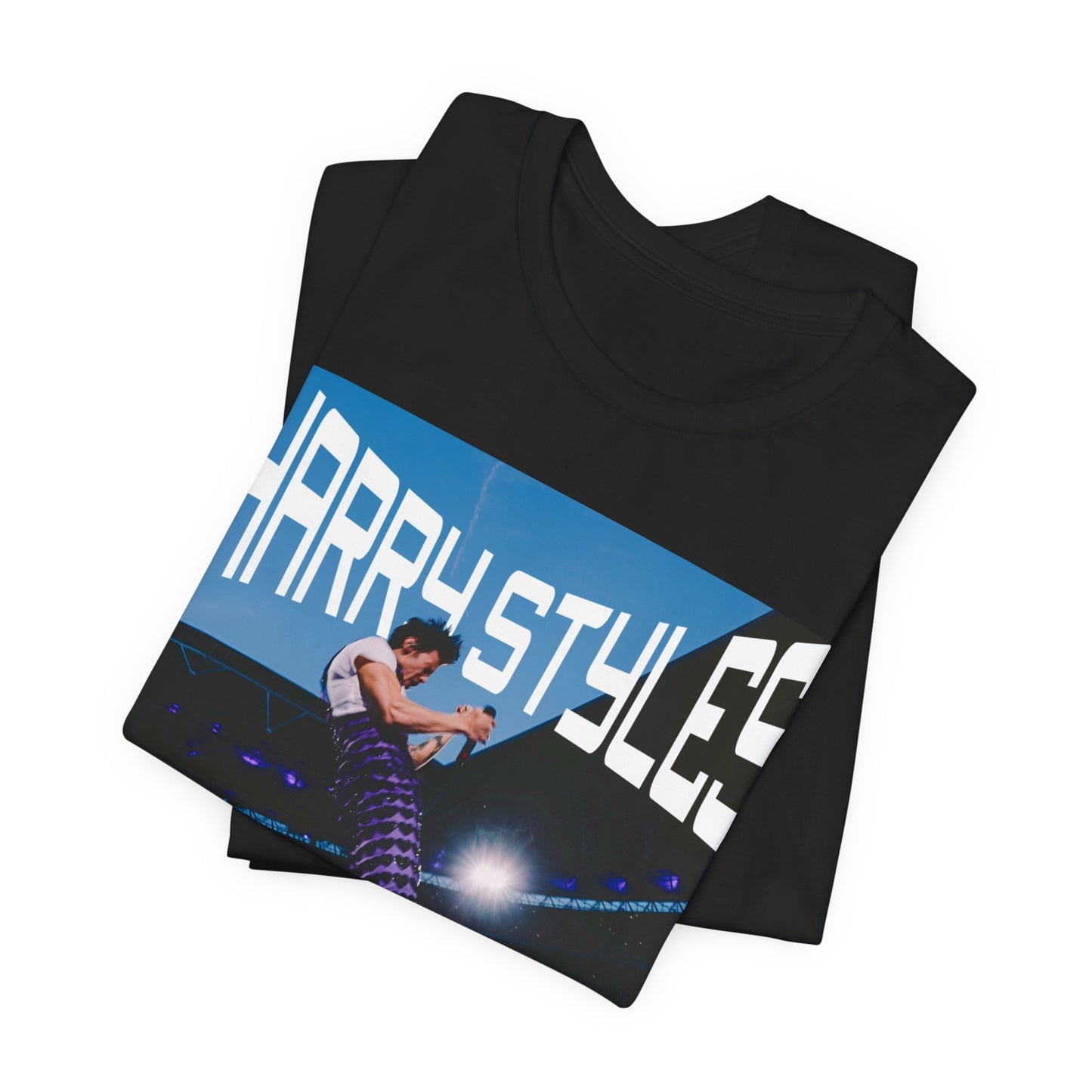 A black graphic t-shirt featuring a graphic or photo of Harry Styles performing live in concert.