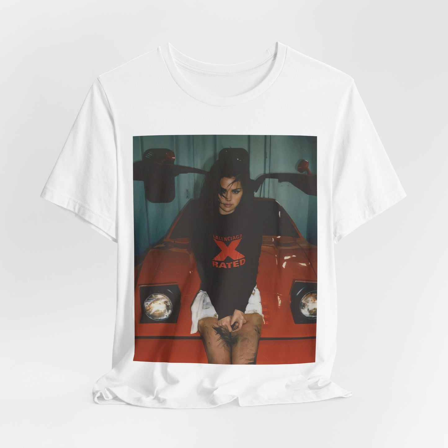 A black graphic t-shirt featuring a photo or graphic of Selena Gomez with a car, designed with an 'X Rated' or edgy aesthetic.