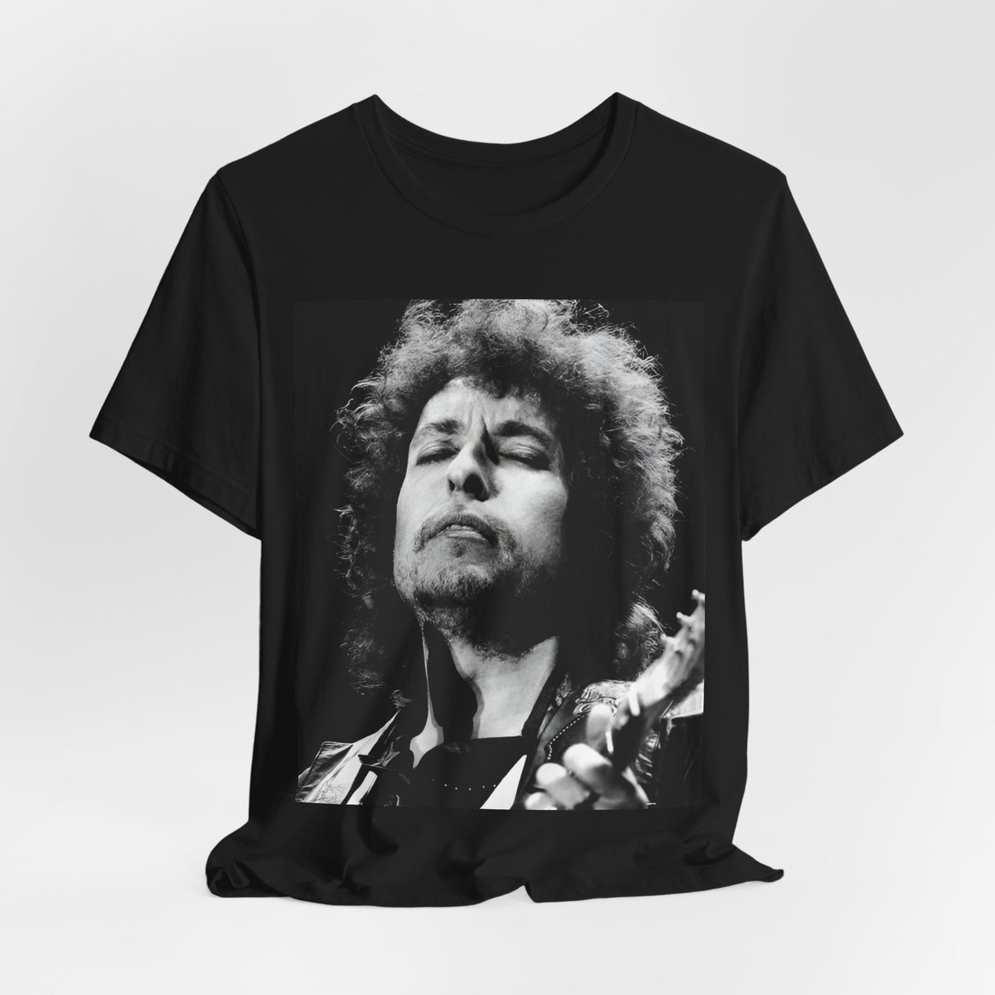 A black graphic t-shirt featuring a retro black and white graphic or photo of Bob Dylan performing live.