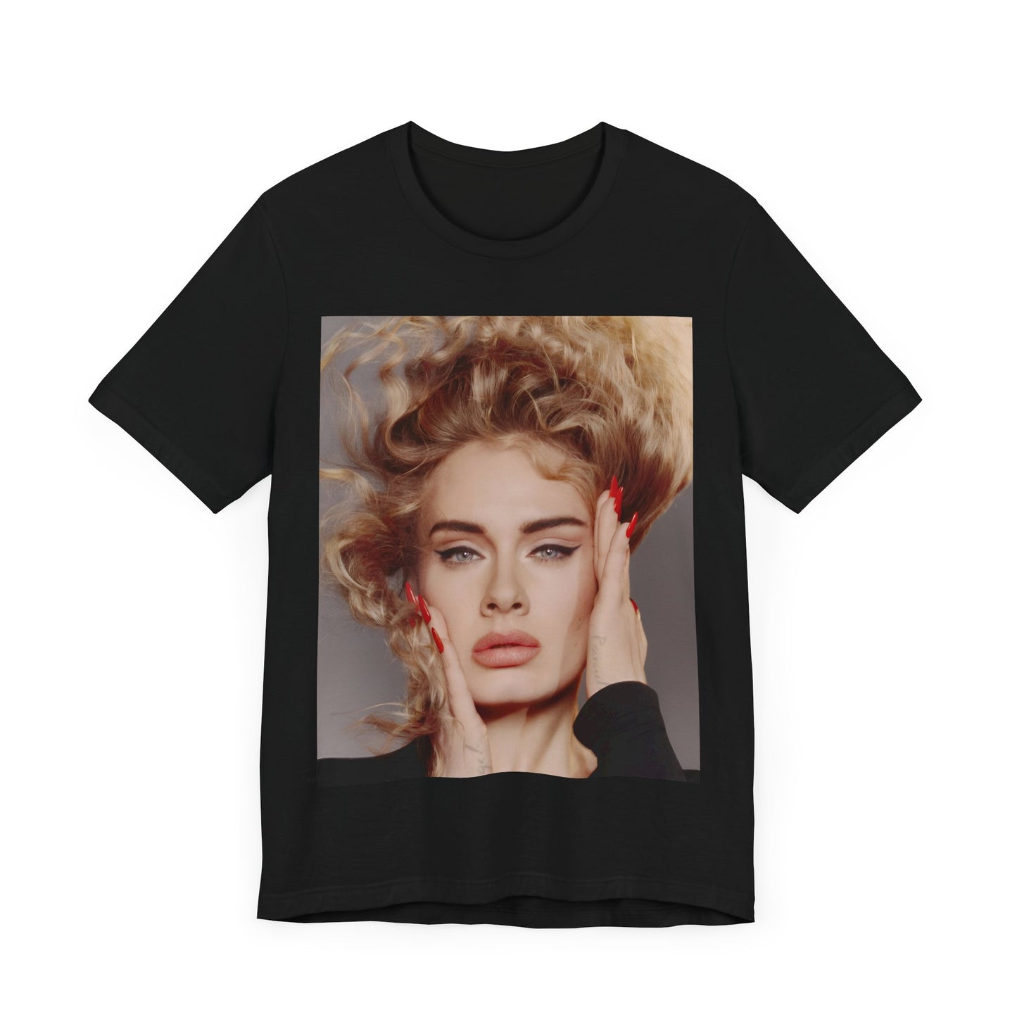 A black graphic t-shirt featuring a detailed, artistic black and white portrait of Adele with her hair dramatically caught in a breeze around her face and her hands gently placed on her cheeks.