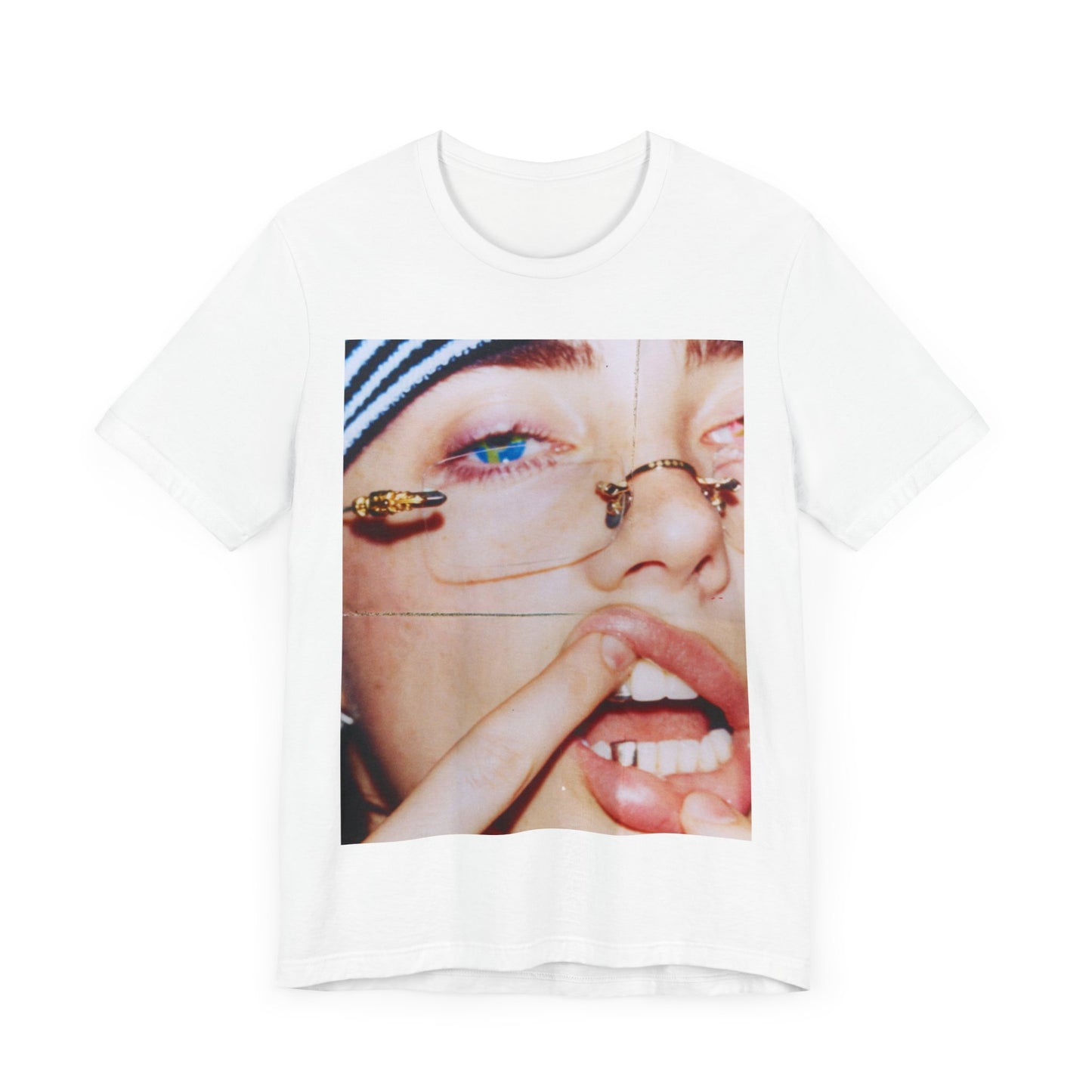 A direct, unfiltered, close-up portrait of Billie Eilish with dark hair looking straight at the camera, printed on a t-shirt.