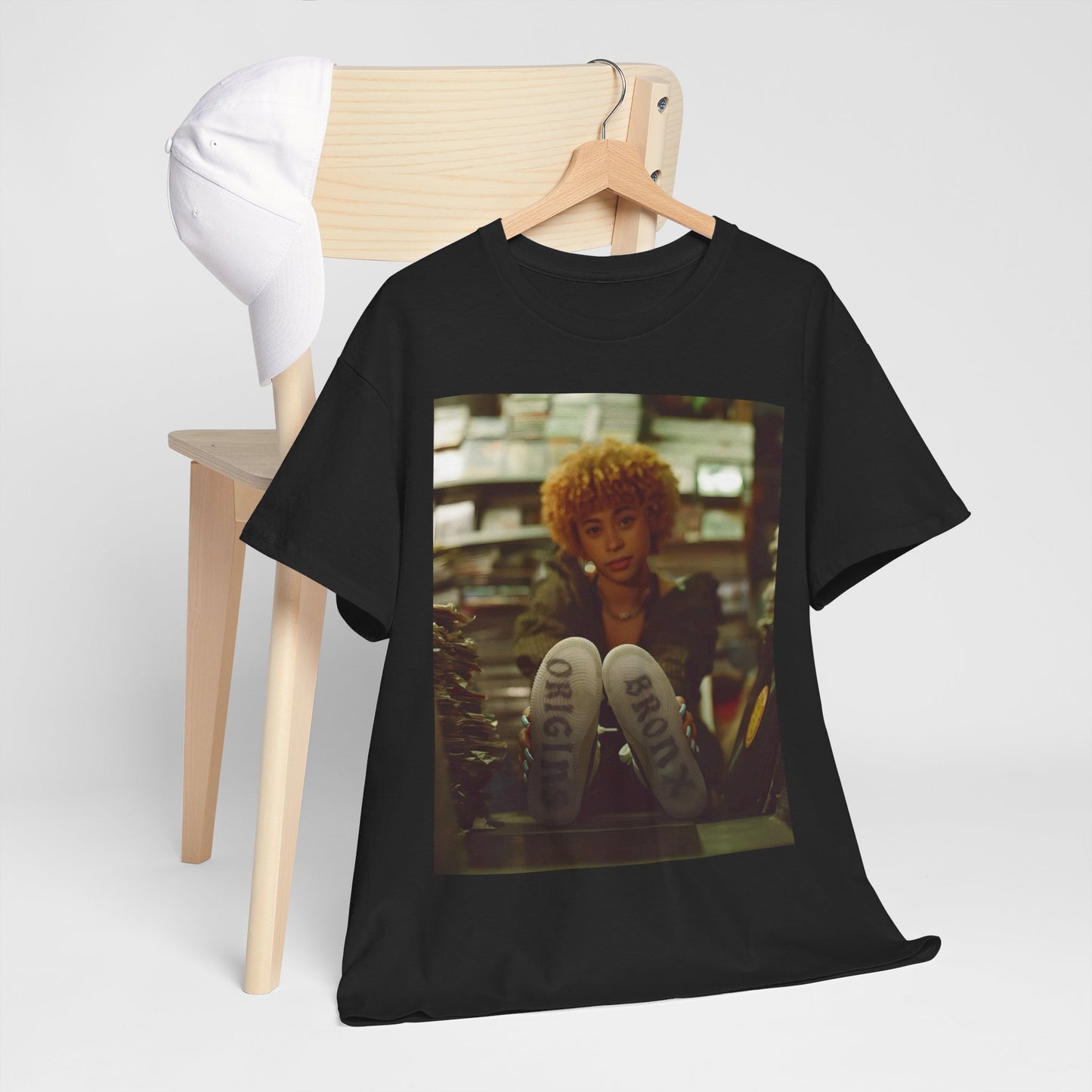 A black graphic t-shirt featuring a stylized graphic of Ice Spice as a TikTok Queen or global sensation.