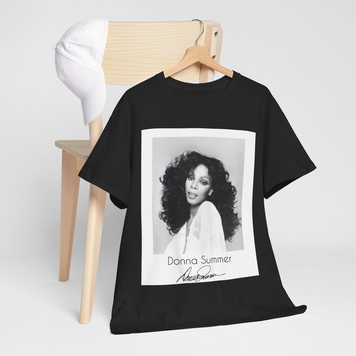 A black graphic t-shirt featuring a portrait of Donna Summer, possibly with her signature or iconic elements.