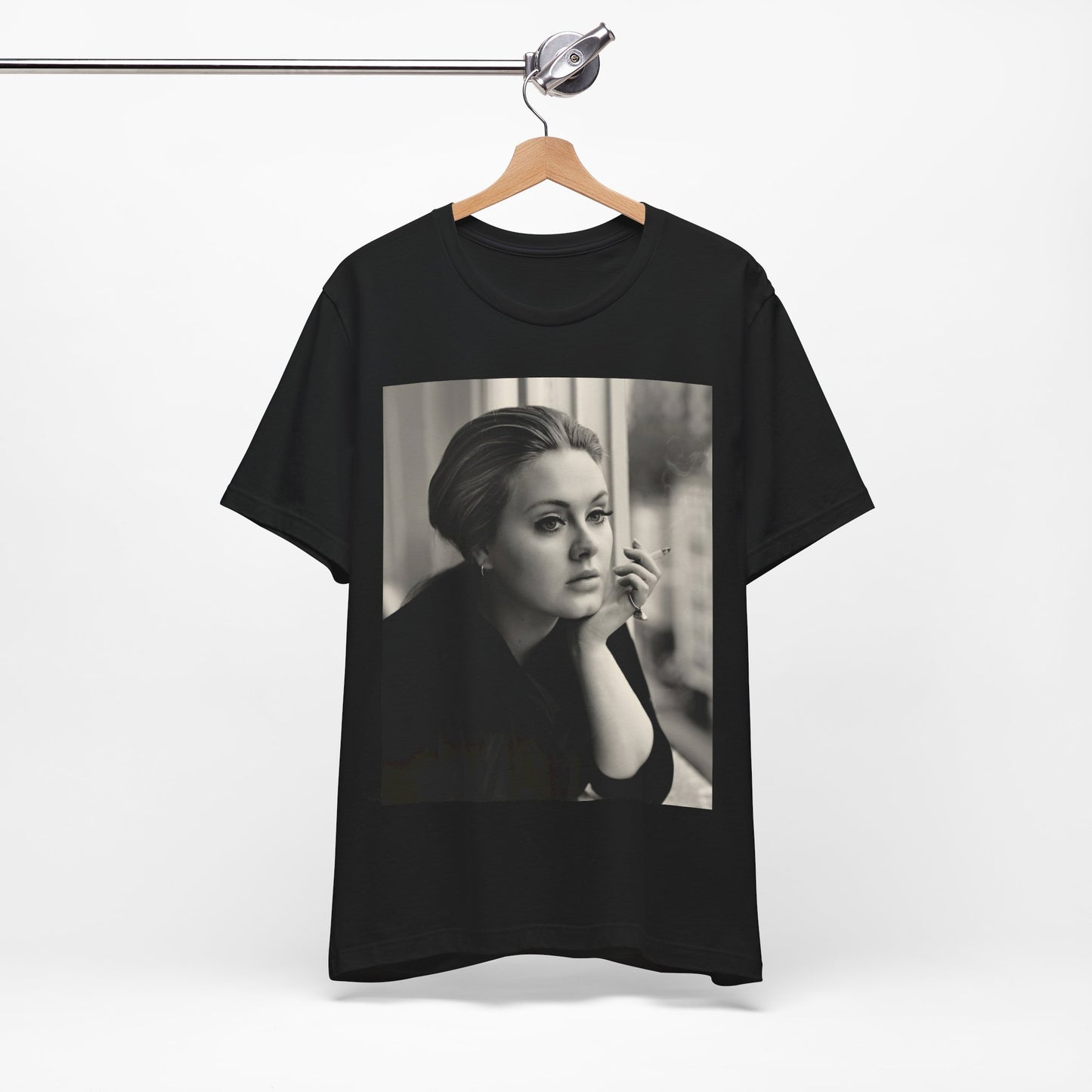 A black graphic t-shirt featuring a black and white photo of Adele, showing her with a serene or thoughtful expression.