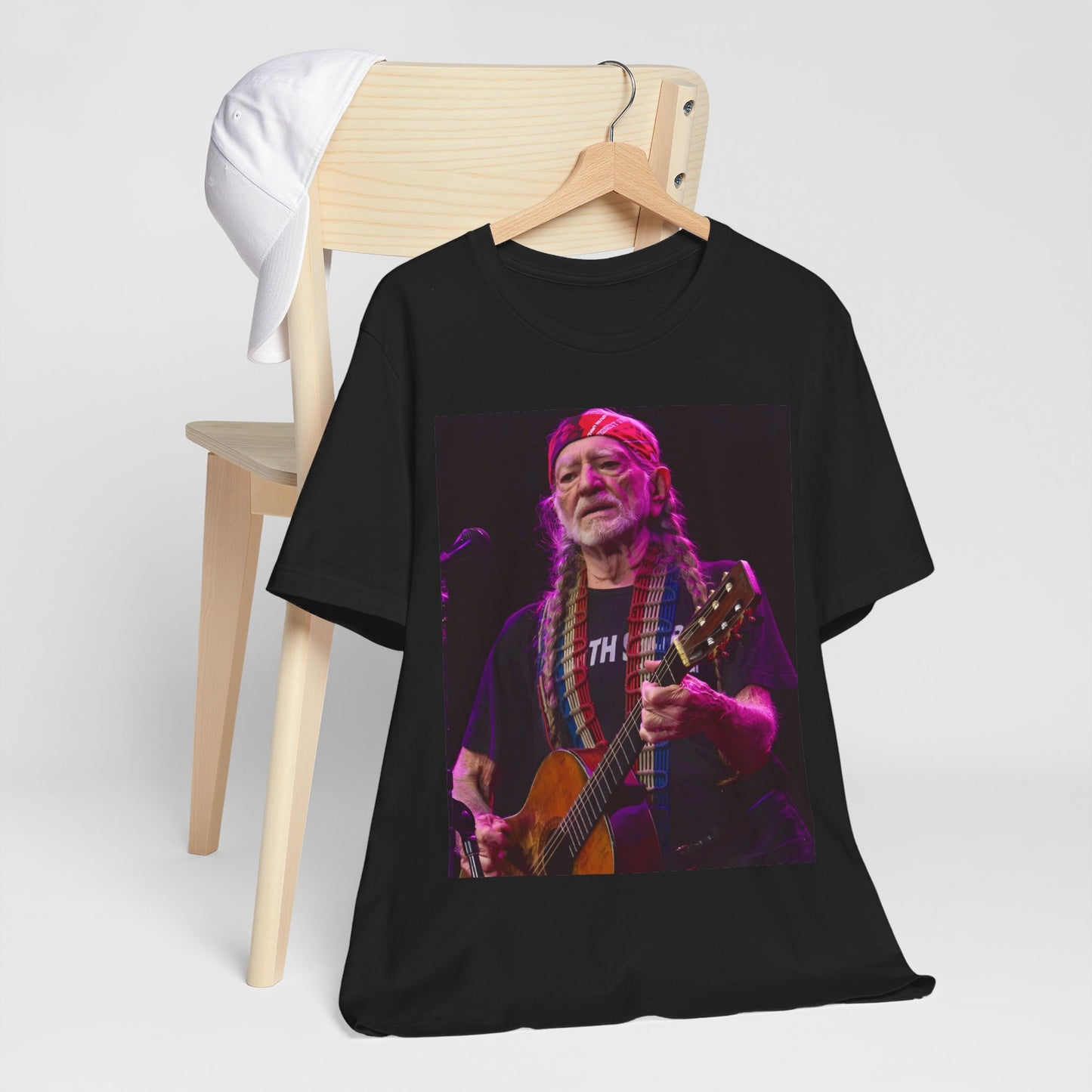 A black graphic t-shirt featuring an outlaw country legend graphic of Willie Nelson.