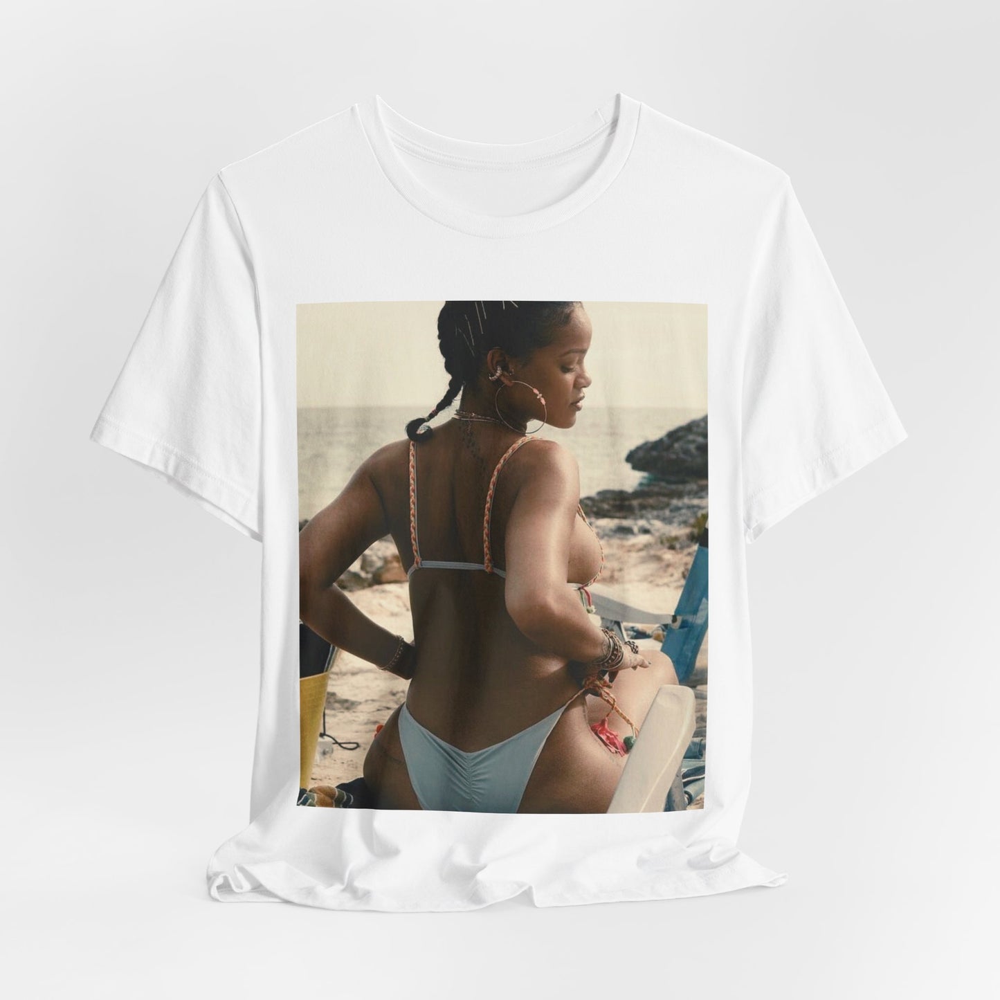 A black graphic t-shirt featuring a graphic of Rihanna as a bikini babe in paradise.