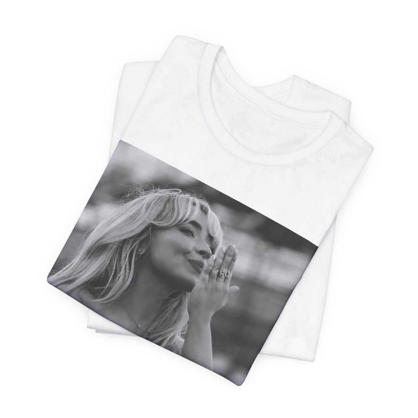 A black graphic t-shirt featuring a graphic or photo of Sabrina Carpenter kissing on stage during a performance.