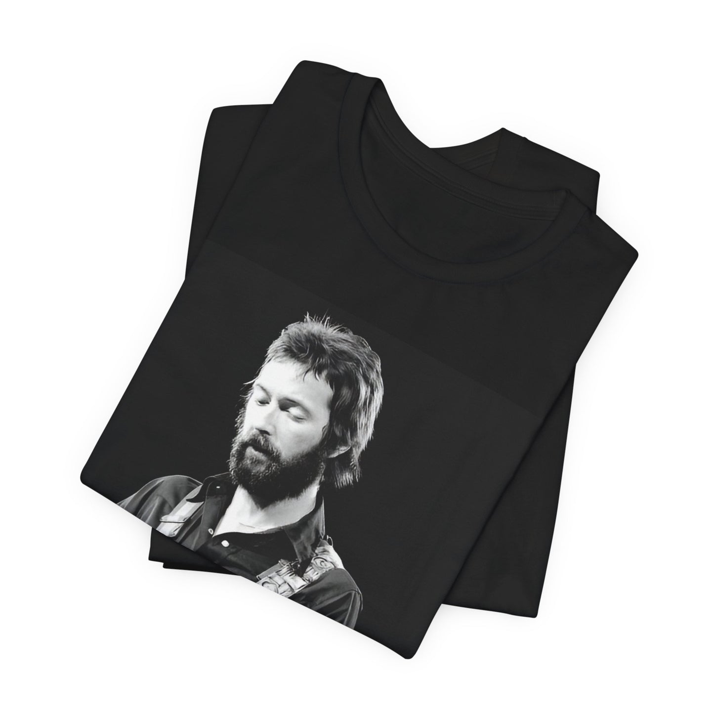 A black graphic t-shirt featuring a graphic or photo of Eric Clapton performing live on stage with his guitar.