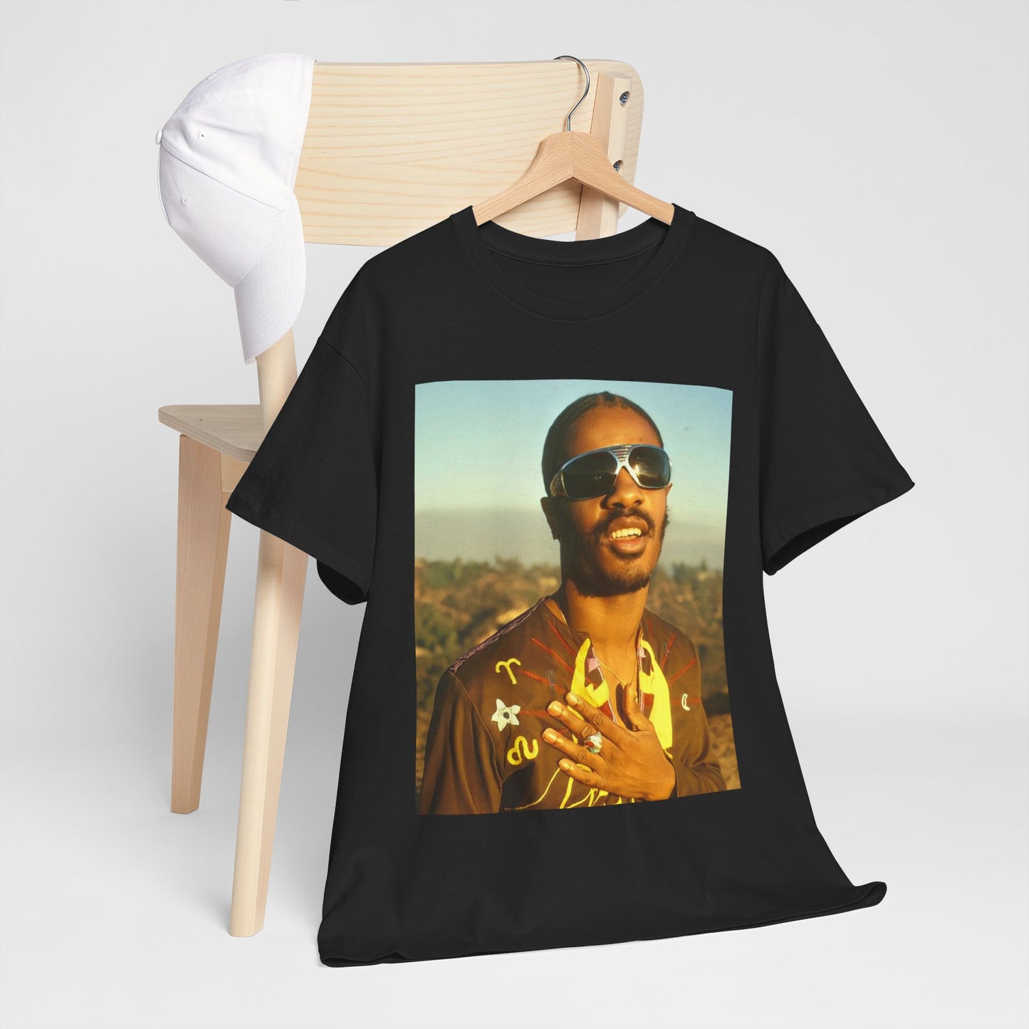 A black graphic t-shirt featuring a 70s cool musical genius graphic of Stevie Wonder.