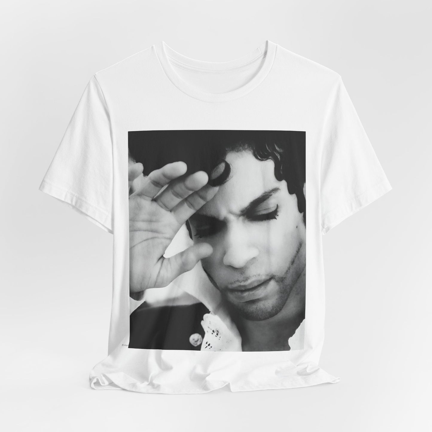 A black graphic t-shirt featuring a black and white graphic or photo portrait of Prince.
