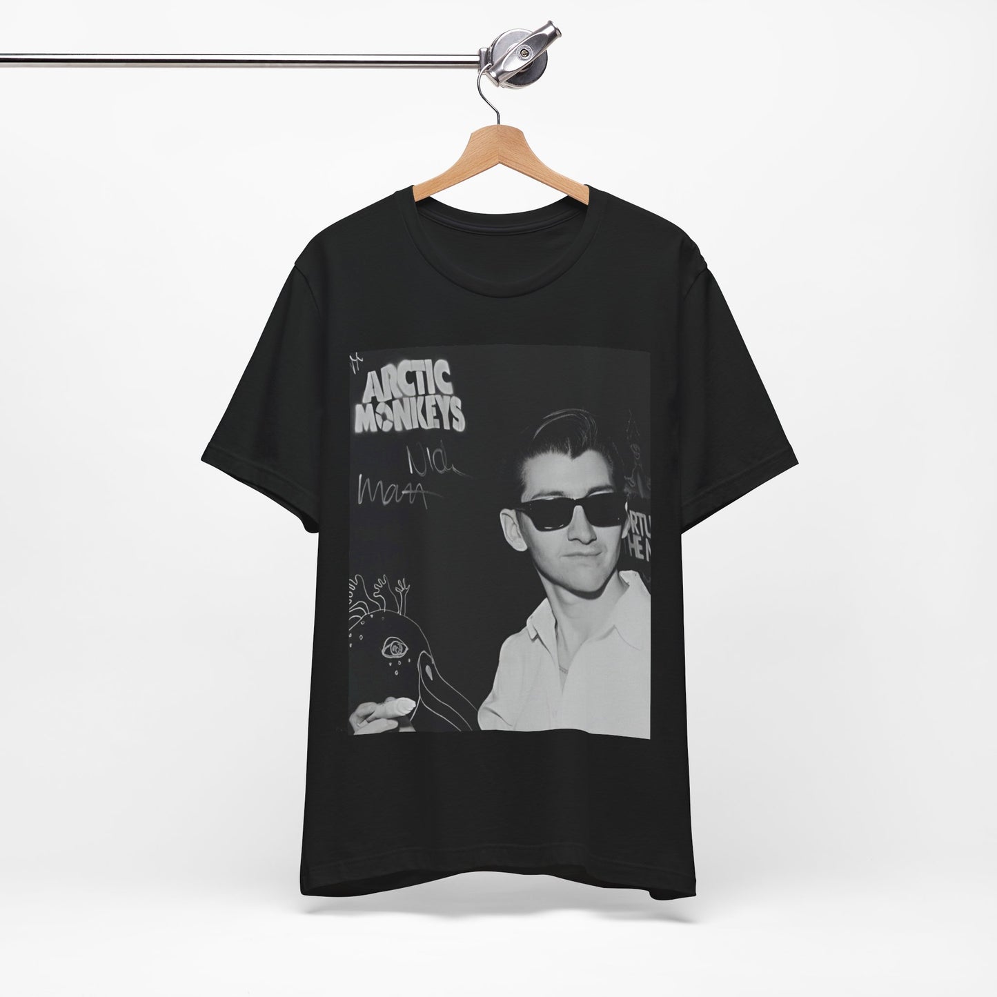 A black graphic t-shirt featuring a black and white portrait photo of Alex Turner from Arctic Monkeys, showing his signature look.