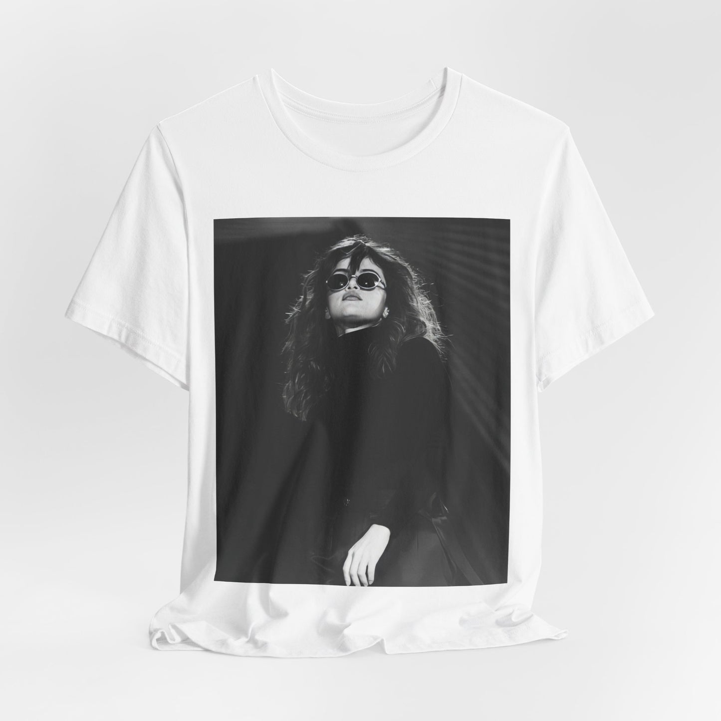 A black graphic t-shirt featuring a black and white, monochrome graphic or photo of Selena Gomez.