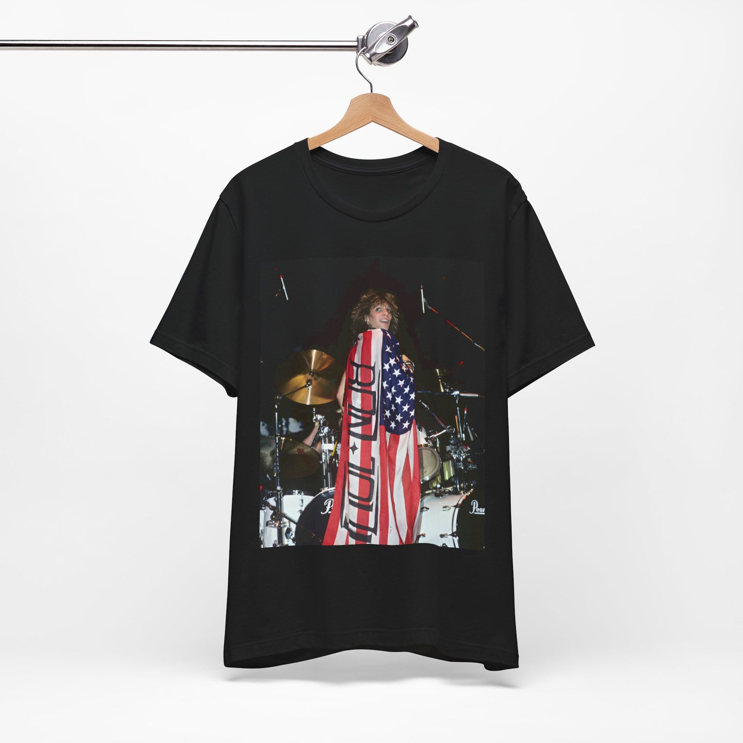 A black graphic t-shirt featuring a graphic of Bon Jovi performing on stage with an American flag as a backdrop.