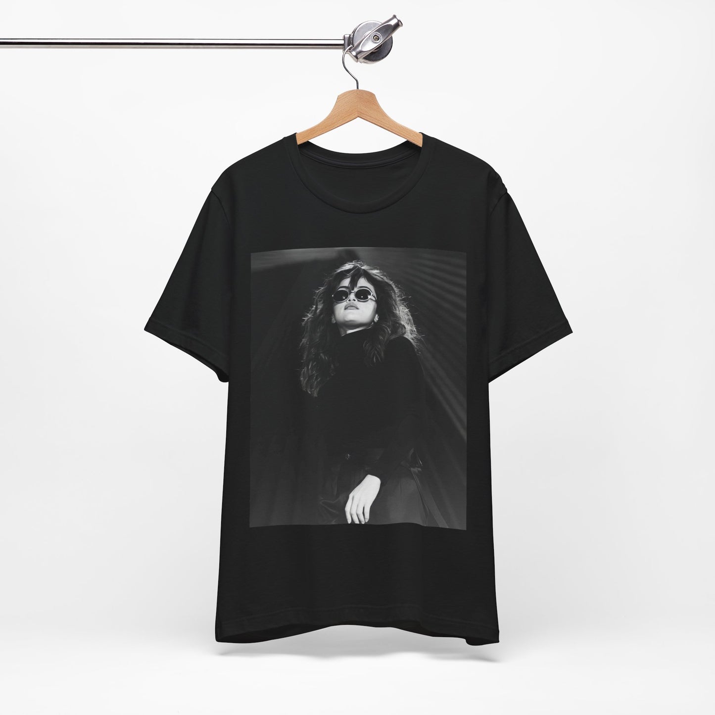 A black graphic t-shirt featuring a black and white, monochrome graphic or photo of Selena Gomez.