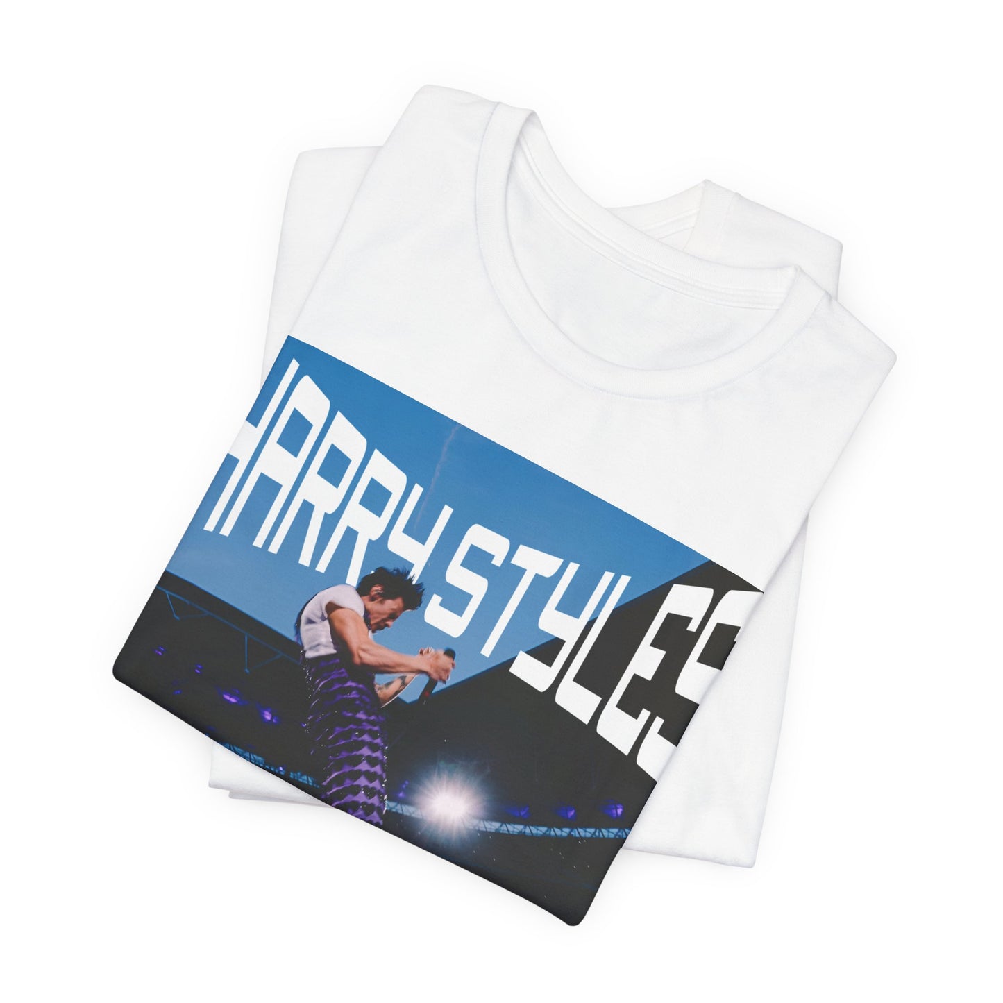 A black graphic t-shirt featuring a graphic or photo of Harry Styles performing live in concert.