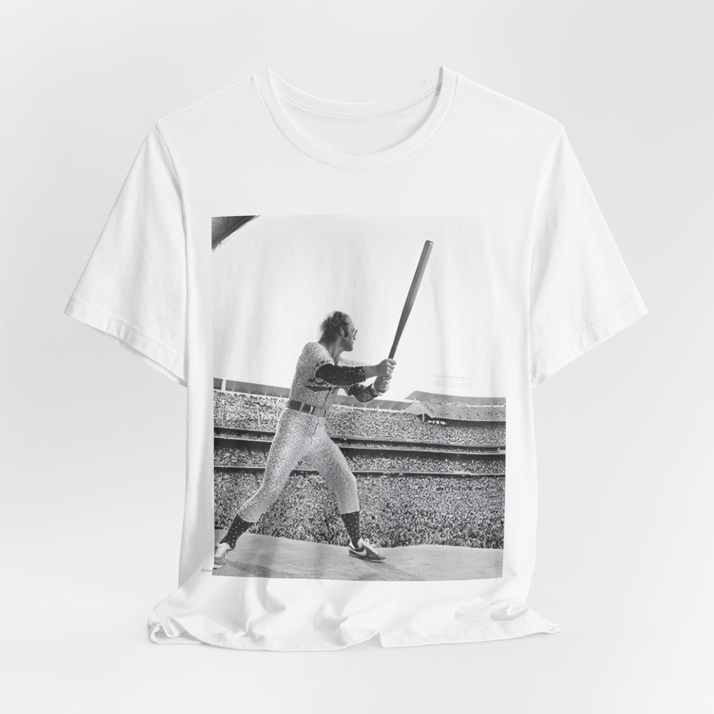 A black graphic t-shirt featuring a black and white graphic or photo related to Elton John's 1975 tour in America.